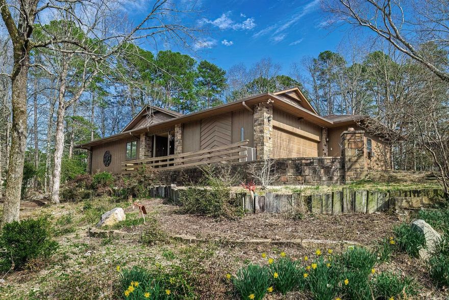 Great house ready for new owners. Popular Madrid floor plan features large living room with built in furniture grade shelving and separate cabinet with bar, fridge and doors. Wood burning fireplace and door to 4 season room complete this lovely area with wood flooring.  Also, you will enjoy the well-appointed dining area between living room and kitchen.  Kitchen has granite counters, lots of very nice wood cabinetry w/pullouts, pantry and breakfast nook with garden window.  Primary suite with his & her closets and remodeled bath with walk in shower.  Two additional well sized bedrooms with full baths complete this wonderful home. Newer ceiling fans, spacious covered deck, wood floors. Two car garage boasts a large workshop.  You really do not want to miss this one.  Property is accessed via Cordoba Way and faces W Villena well above the road and has a nicely wooded back yard.  Hot Springs Village is a 26,000-acre gated community with 11 lakes, 9 golf courses, white sand beach, hiking trails, pickle ball, fitness center, indoor and outdoor pool, tennis and SO MUCH MORE.  One time POA buy-in fee $2000 due at closing. Occ May 1.  See agent remarks