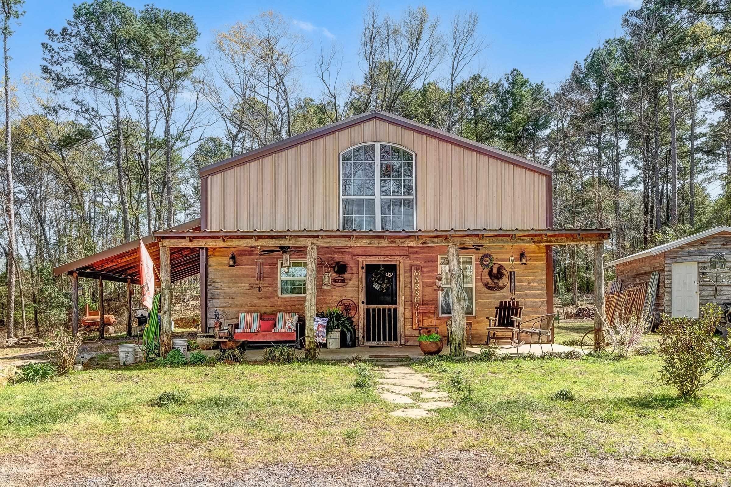 What started out as a shop turned into a home. Owner built home in 2018. This 2828 sqft shop/home has 1708 of heated and cooled living space 3 bedrooms and 2 baths. The shop space is 1120 sqft of heated and cooled workspace and a half bath. The home sits on 7.5 acres just outside the city limits, with city water and septic system. The front 2.88 acres along N Ninth are in the city limits of Dequeen, AR. natural gas available but propane gas in use on homesite. Outdoor storage buildings, RV set up and enough land to grow on.