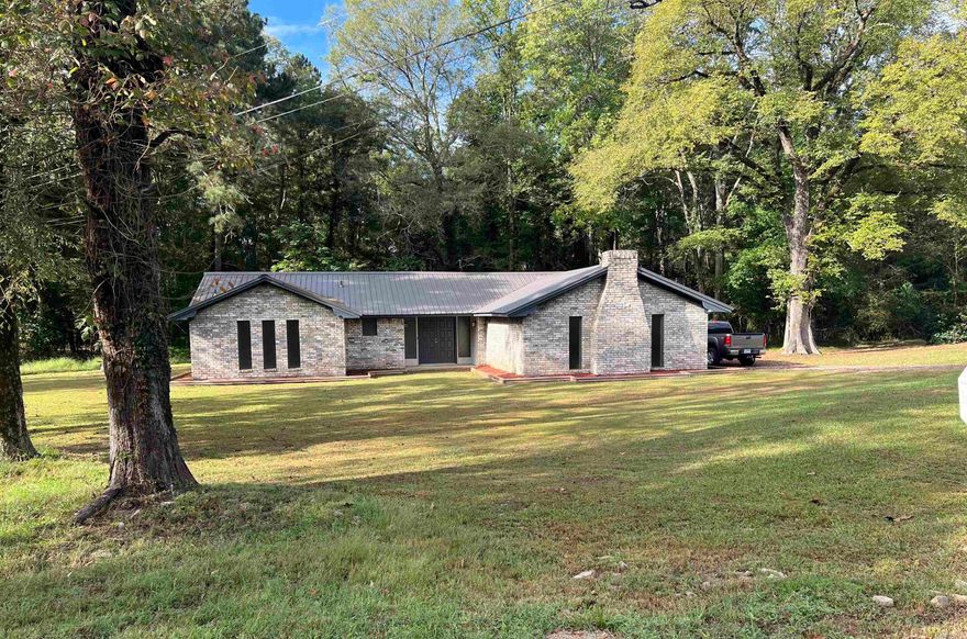 Like- New Home!  Step into this charming home beautifully refreshed for modern living! Featuring three spacious bedrooms and two updated bathrooms, this home offers both comfort and style. The large den welcomes you with a cozy fireplace—perfect for relaxing evenings. You’ll love the brand-new countertops and stylish light fixtures that add a fresh, contemporary touch throughout. A dedicated office with elegant double doors makes working from home a breeze, while the metal roof adds durability and curb appeal. Thoughtfully landscaped with new flower beds, every detail of this home has been lovingly updated to create a warm, inviting space you’ll be proud to call your own.