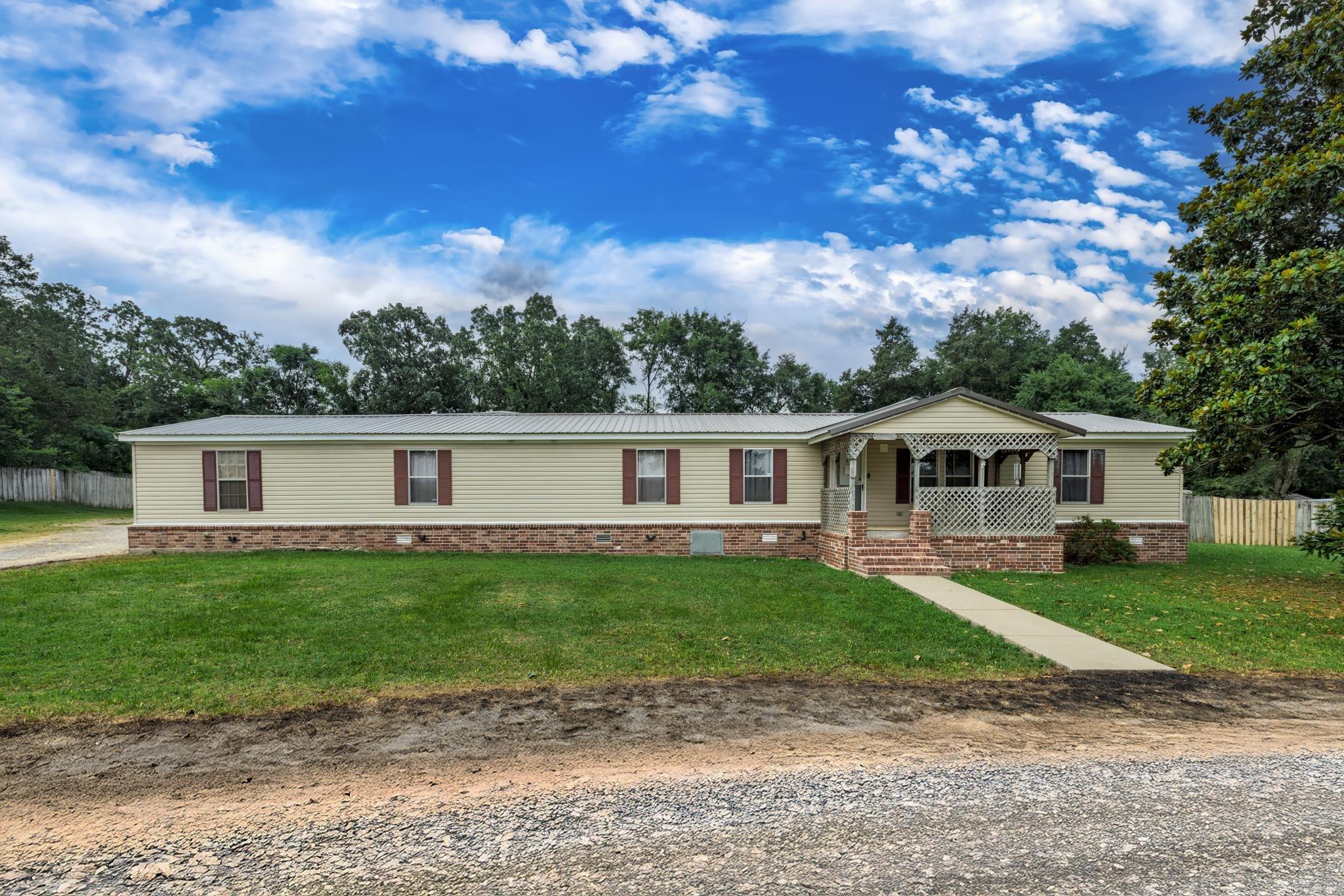 Welcome to this beautifully updated six-bedroom, three-bath home perfectly situated near both Lake Hamilton and Lake Ouachita. Sitting on over an acre of land, this property offers space, comfort, and functionality for any lifestyle. Inside, you’ll find brand new LVP flooring throughout and a stunning kitchen featuring granite countertops and a massive walk-in pantry. The spacious primary suite offers a large bathroom complete with a jetted tub, walk-in shower, and plenty of room to unwind. The living area is centered around a cozy log-burning fireplace, creating the perfect gathering space for family and friends. This home is full of thoughtful updates from top to bottom. Step outside to enjoy the huge fenced-in backyard, perfect for entertaining or letting pets roam. Car enthusiasts and hobbyists will love the oversized, heated and cooled four-car garage, plus there’s a shop in the backyard for even more workspace or storage. With so much to offer and such a prime location near two of the area's most popular lakes, this home truly has it all.