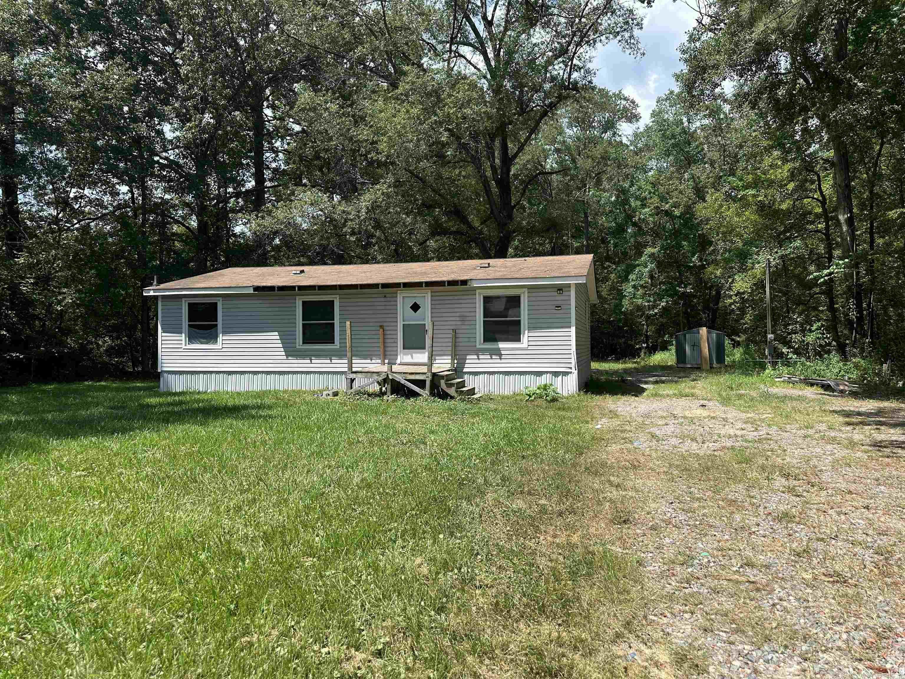 Charming country retreat! This 3BR/2BA home is nestled among mature trees that offers privacy and space to spread out! This hidden gem is ideal for your family or to add to your rental portfolio!! Large, open living space! Primary is apart from the additional 2 Bedrooms. Refrigerator, Washer & Dryer will stay! Located close to all amenities! Sq. Ft. is approximate. Please measure. AGENTS SEE REMARKS!!!