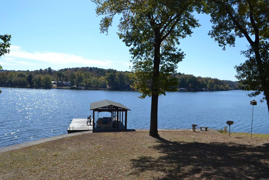 This one of a kind property on Lake Catherine has a main house (2550 sf) w/ 3 BR & 2 1/2 baths w/ a large living room on both levels and a separate guest house (1120 sf) w/ 3 BR & 1 1/2 baths. Each home has its own electrical supply creating 2 separate addresses but sit on one 2 acre parcel (MOL) of land.  Both houses have a total combined living area of approx. 3670 sf. (see agent remarks regarding sf). Both houses have full kitchens and washer/dryers.  Property is located in the county and does not require city business permitting to operate a nightly rental offering an unlimited business opportunity.   Property offers over 250' of shoreline with a rock seawall, a 2 stall covered boat house with overhead garage doors, a 1 stall covered boat slip with swim platform, a 20' x 20' covered cooking/party shack and over 1500' of outdoor decks.   You must experience all this property has to offer to truly appreciate it. Located off of the Malvern Hwy and in the Lakeside School District it is just minutes from the bypass.