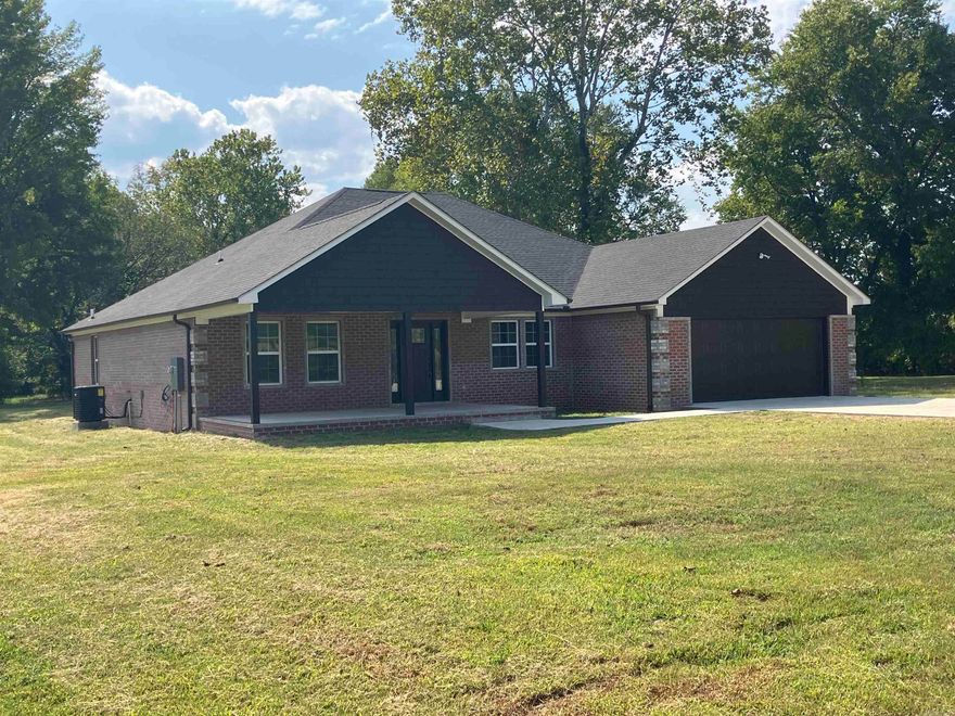 Quality & craftsmanship offered throughout this spacious new constructed dwelling on the edge of Clarksville on over 6 acres. Beautiful brick exterior w/ unique design. Large covered front & rear porches. Paved driveway. Open concept w/ spacious living/dining/kitchen areas. 4 BR’s. One located upstairs w/ access to the attic which includes over 120 sq.ft of storage space. The master includes a tray ceiling, walk-in closet, & custom tiled shower. Oversized laundry. Laminated wood floors. The home will be completed prior to closing. Kitchen in progress.