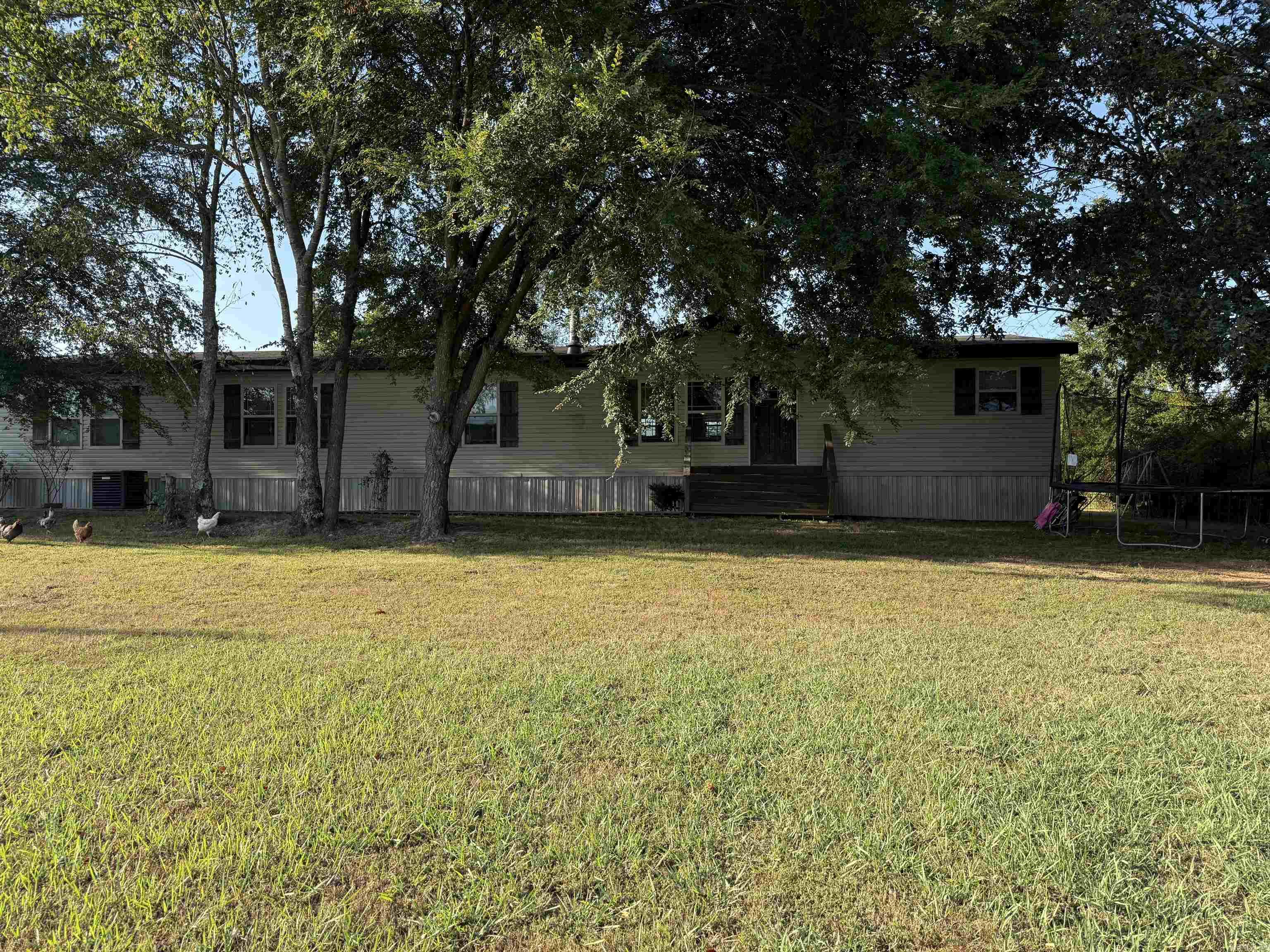 Beautiful Deer Valley Manufactured home (approx 2016) with five Acres M/L located in Marmaduke, Arkansas. Located close to school and local amenities. This home has four bedrooms, 3 baths, and approx 2880 sq ft. You will love the open concept living/dining combination with wood burning fireplace. Enjoy prepping family meals in the large kitchen with huge kitchen island. The kitchen island is perfect for homework after school, and perfect for entertaining family and friends, or family mealtime. You and your family will appreciate the two living spaces, perfect for watching the game in one room, or enjoying reading a book by the wood burning fireplace in the other living space. The bedrooms are large and have lots of closet space. The primary bedroom has a large ensuite with garden tub and shower as well as large walk in closet. If you are looking for property with some acreage this is perfect with five serene acres. Home is located off the highway and has a very convenient location. Country living close to town and school. Heating and air unit was replaced last year. Don't wait to see this beautiful home, call today to schedule a time to see it!