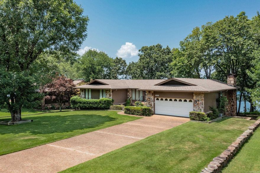 LAKEFRONT JEWEL with an AMAZING VIEWS of GREERS FERRY LAKE!  LOCATION! LOCATION! LOCATION!  Enjoy Panoramic views of the lake from almost every room in the house. Upper and Lower Covered Decks along the entire back of the home, four separate living areas, a huge screened porch, 2 rock fireplaces, vaulted ceilings, 2 car garage, ample parking and much more.  Master Bedroom plus two additional bedrooms on main level. Downstairs has two additional bedrooms, two large living areas, a small kitchenette, a shop area and it's own separate entrance.  HWH - 2020 and HVAC 2020 and 2022. Storage Galore. Well Maintained. Needs Updating. Beautiful Landscaping. Tons of Potential.  This home would make an awesome full-time home or a wonderful investment opportunity.  No Interior Pictures due to recent Estate Sale.