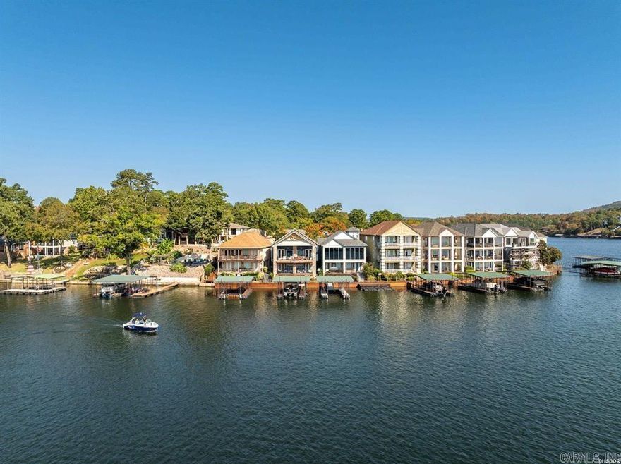 Welcome to your own piece of "paradise" on Lake Hamilton! This stunning townhome is located inside the upscale community of Paradise Lake Village and has main channel views that will leave you in awe every single day. Step inside and be greeted by a spacious open concept kitchen and living area.  The main level features the Master bedroom, living area and large open kitchen. You will have a view from any of them. Plenty of room to chat with family or friends while you cook. The kitchen features a  breakfast bar and wet bar. Stainless steel appliances and tons of storage. You will enjoy your morning coffee with a view from either of the decks on each level. The Master bedroom also offers private access to the deck. The bathroom is large and features a gorgeous shower, water closet and double vanity.   The home features convenient laundry facility options on both the upper and lower levels, making chores a breeze. Cozy up in the living area by the fireplace or head to the second living area downstairs, where you can relax and unwind while taking in the beauty of the lake. You'll find two large guest bedrooms on the lower level as well. Cont'd in agent remarks...