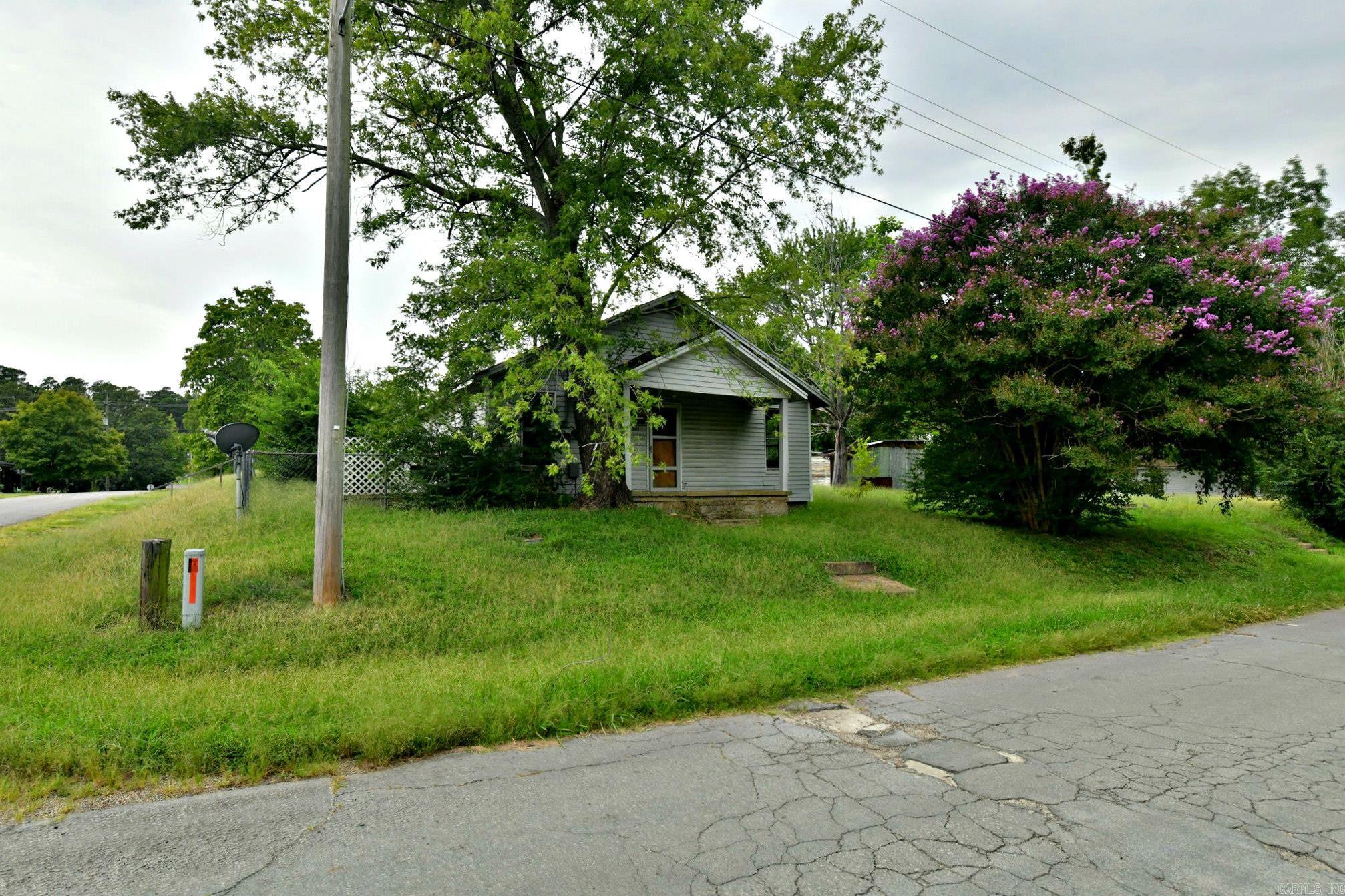 This charming older home sits on a large corner lot in town at the base of scenic Rich Mountain, where the proposed bike trails will soon bring even more activity and excitement to the area. With 2 bedrooms and 1 bath, the house is being sold as-is, giving the next owner the perfect opportunity to make it their own. In need of repairs, itās an ideal fixer-upper for someone looking to personalize a home to fit their needs or for an investor seeking a great opportunity. An alley in the back provides extra access, and the generous lot offers space for outdoor projects, gardening, or expansion. Located in Mena, a welcoming town known for its small-town charm, outdoor recreation, and proximity to the Ouachita National Forest, this property combines convenience, potential, and the freedom to create a home exactly as you envision. Donāt miss this chance to turn this property into your dream home or a profitable investment.