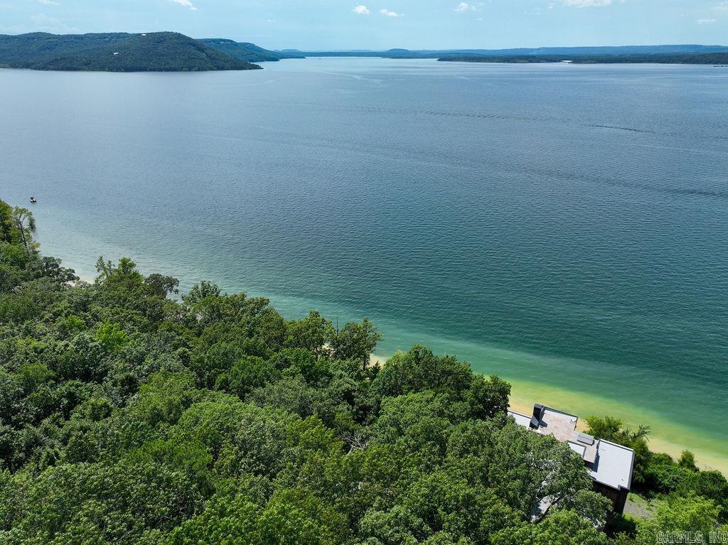 Premier Lakefront Estate on Eden Isle Nestled on the most coveted lot in Cleburne County’s prestigious Eden Isle community, this exceptional property offers unrivaled lake views from both the main residence and the charming guest house. Designed for comfort and elegance, the spacious main home features expansive windows that frame Greers Ferry Lake like a living masterpiece. The guest house provides privacy and flexibility—ideal for hosting friends, extended family, or even generating rental income. Whether you're enjoying sunrise coffee on the deck or sunset gatherings by the water, this property delivers a lifestyle of serenity and sophistication in one of Arkansas’ most exclusive lakefront enclaves.