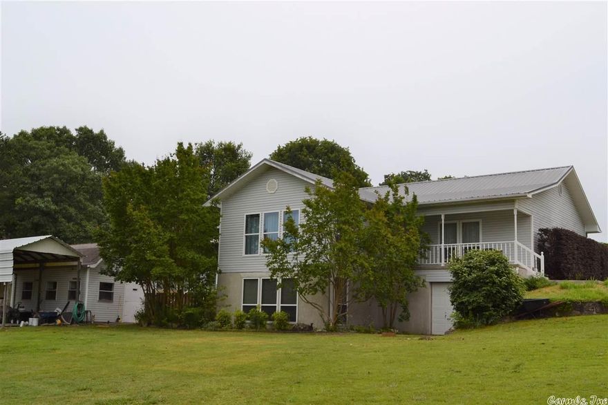 This well-built and uniquely custom-crafted property is perfect for anyone looking for a peaceful and private atmosphere. With basement walls made of poured concrete, a storage/workshop building, 2 car garage on main level, and a bonus garage on the lower level, you have plenty of storage and workspace. Inside the home, you will find lots of insulated windows to greet you with natural light, a fireplace, and a large open formal dining room with vaulted ceiling. The chef's kitchen has a large wrapping kitchen island that provides extra seating, custom cabinets, and a stainless French door refrigerator. The master bedroom has a large walk-in closet and custom cabinets in the master bath. The walk-in mudroom/laundry room has bonus storage and a space for a freezer or 2nd refrigerator. The walkout grand-sunroom has windows surrounding it and is perfect for growing plants year round and it overlooks your private outdoor entertainment area which is perfect for hosting guests or relaxing in privacy. This home is must-see for those searching for their dream home.