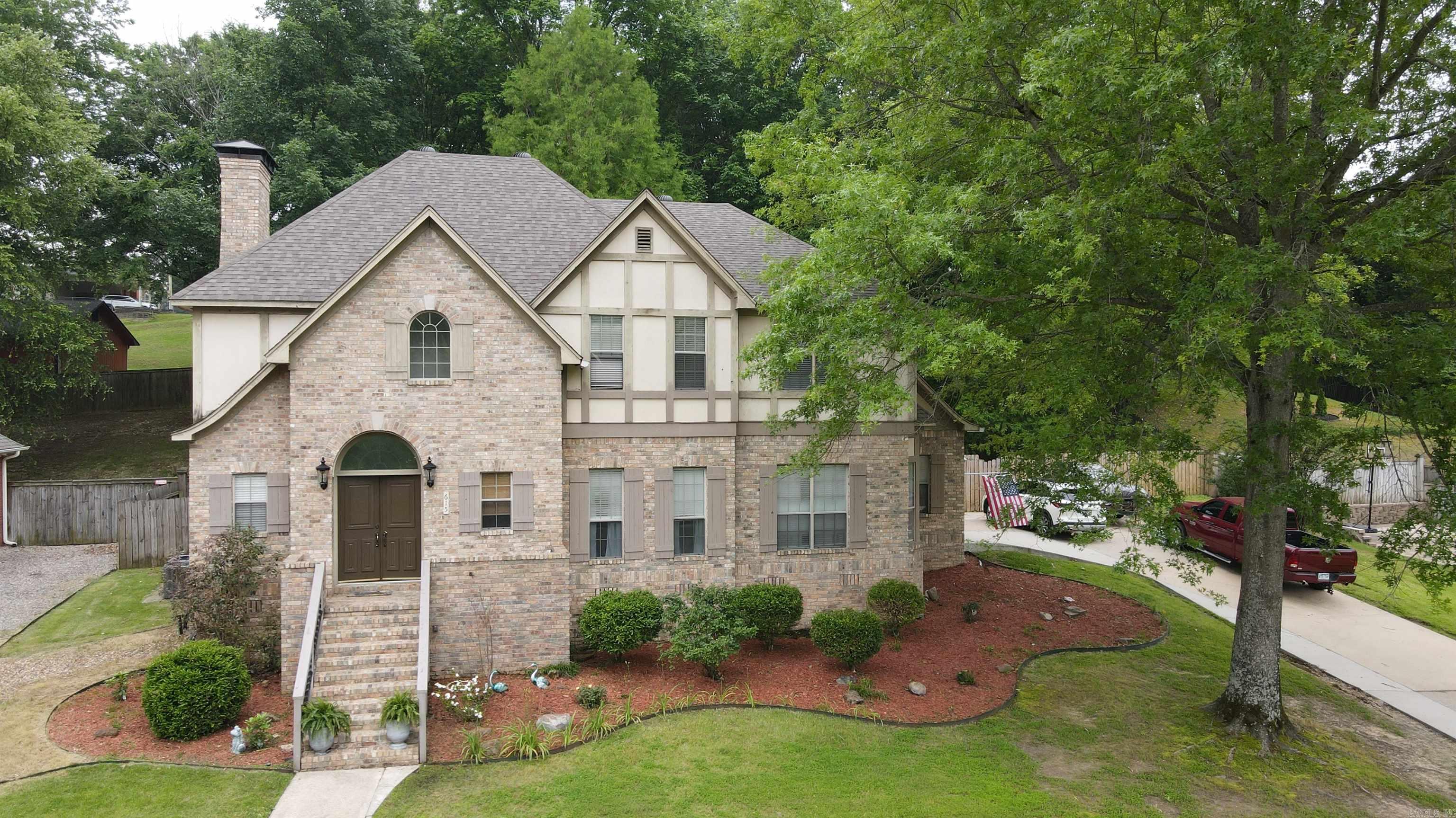 There's so much to fall in love with in this beautifully maintained 4-bedroom, 3-bathroom Tudor-style home nestled in the heart of Miller Cove. From the moment you step into the charming 2-story entryway with built in reading nook, you’ll feel the warmth and character this home offers. Upstairs, you’ll find all four spacious bedrooms, including a convenient Jack and Jill bedroom/bathroom setup and private vanity area. The home boasts an abundance of storage and built-ins throughout. The newly updated kitchen features granite countertops, stainless steel appliances, and flows seamlessly into the open concept living area, ideal for entertaining and everyday living. Additional highlights include double set of French doors that lead you outside to an enclosed patio—great for relaxing or entertaining. The swing set can convey. The water heater replaced in 2025 and roof replaced in 2021. Don’t miss your chance to own this timeless storybook home in one of the area's most sought-after neighborhoods!