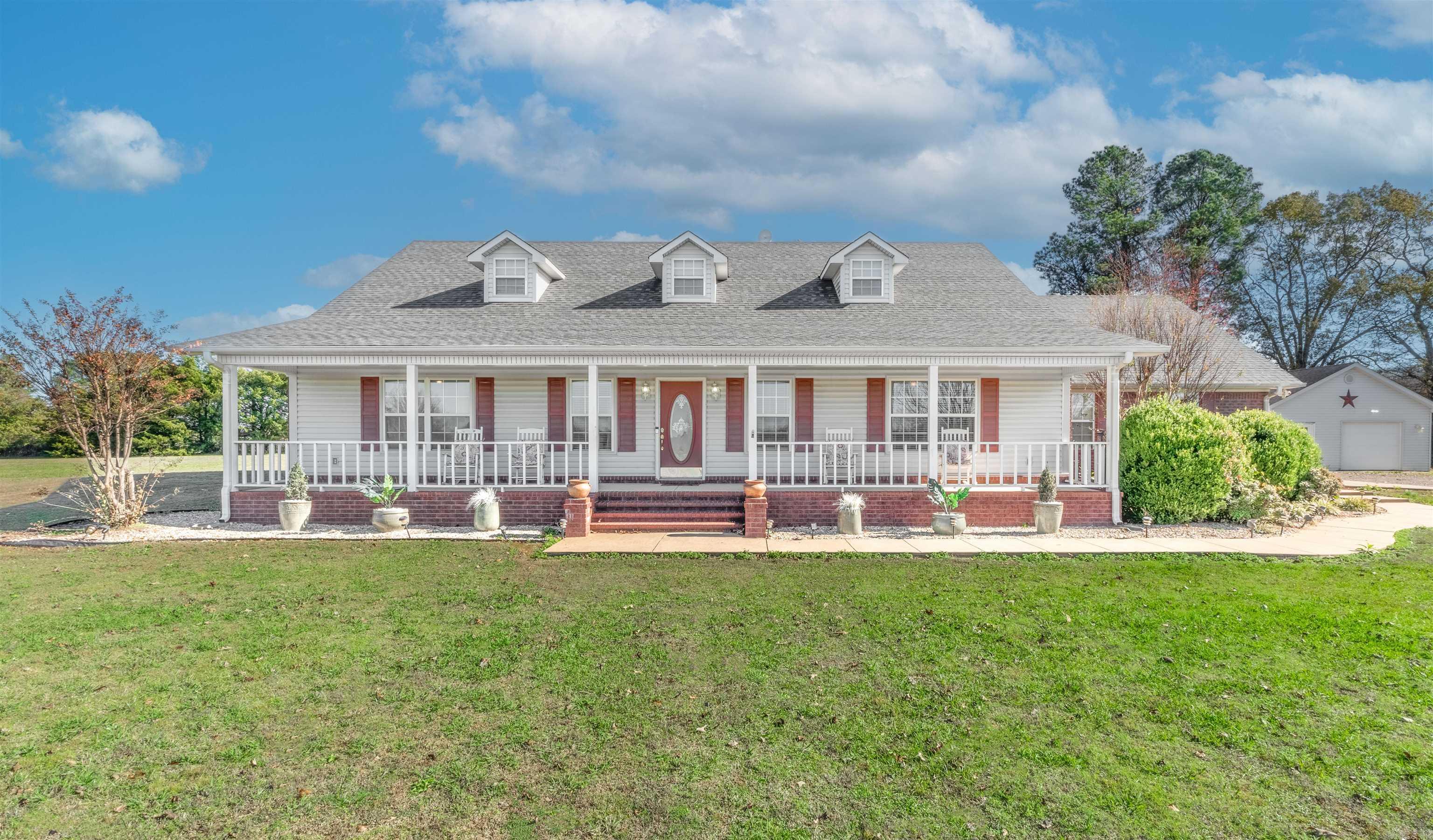 Country living at it's best!! This spacious 4- bedroom, 2-bathroom all electric home offers the perfect blend of rural tranquility and modern convenience, located just outside Morrilton city limits. Sitting on 4 beautiful acres, the property provides ample space for relaxation. The kitchen offers granite countertops, complemented by stainless steel appliances. The primary suite is located on the main floor and features double vanities, a walk-in shower, and a jetted tub. The 4th bedroom is upstairs along with a huge bonus room/game room! Home has a large covered front porch, a screened-in back porch and a covered patio making it perfect for outdoor entertaining! There is a 24x30 workshop with power that has a FEMA-registered storm shelter. A brand new roof completes this move-in-ready home!
