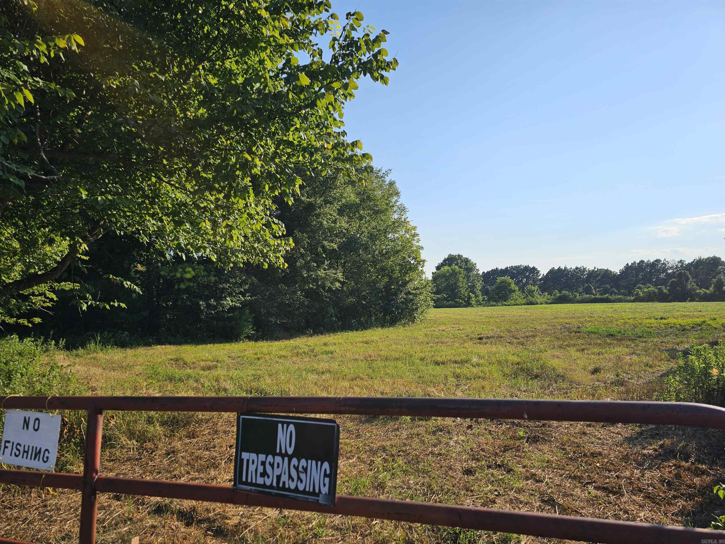 This beautiful 5.93-acre property offers the perfect blend of privacy and convenience. Featuring an approximately 3-acre stocked pond, it's an ideal setting for nature lovers and fishing enthusiasts. A level, cleared area is ready for your dream home, with water and electricity available at the street. Enjoy peaceful country living just minutes from town on this one-of-a-kind homesite.