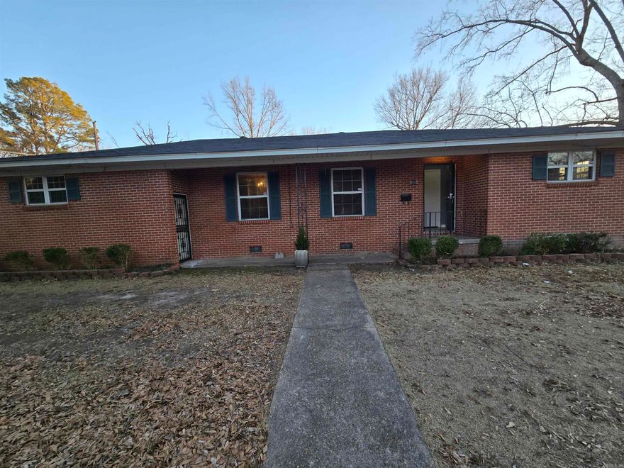 Welcome to this newly remodeled move-in ready home. This open floor plan has a large kitchen and dining area. Accented entertainment niche in the living room.  A primary suite with a large walk-in closet and bathroom.  There is an attached 2.5 car garage with a workroom and a dedicated laundry room.  The backyard is completely fenced with an additional covered carport and concrete patio area.  All interior walls are freshly painted and there are original hardwood floors throughout.  Schedule time to view this solid brick home.