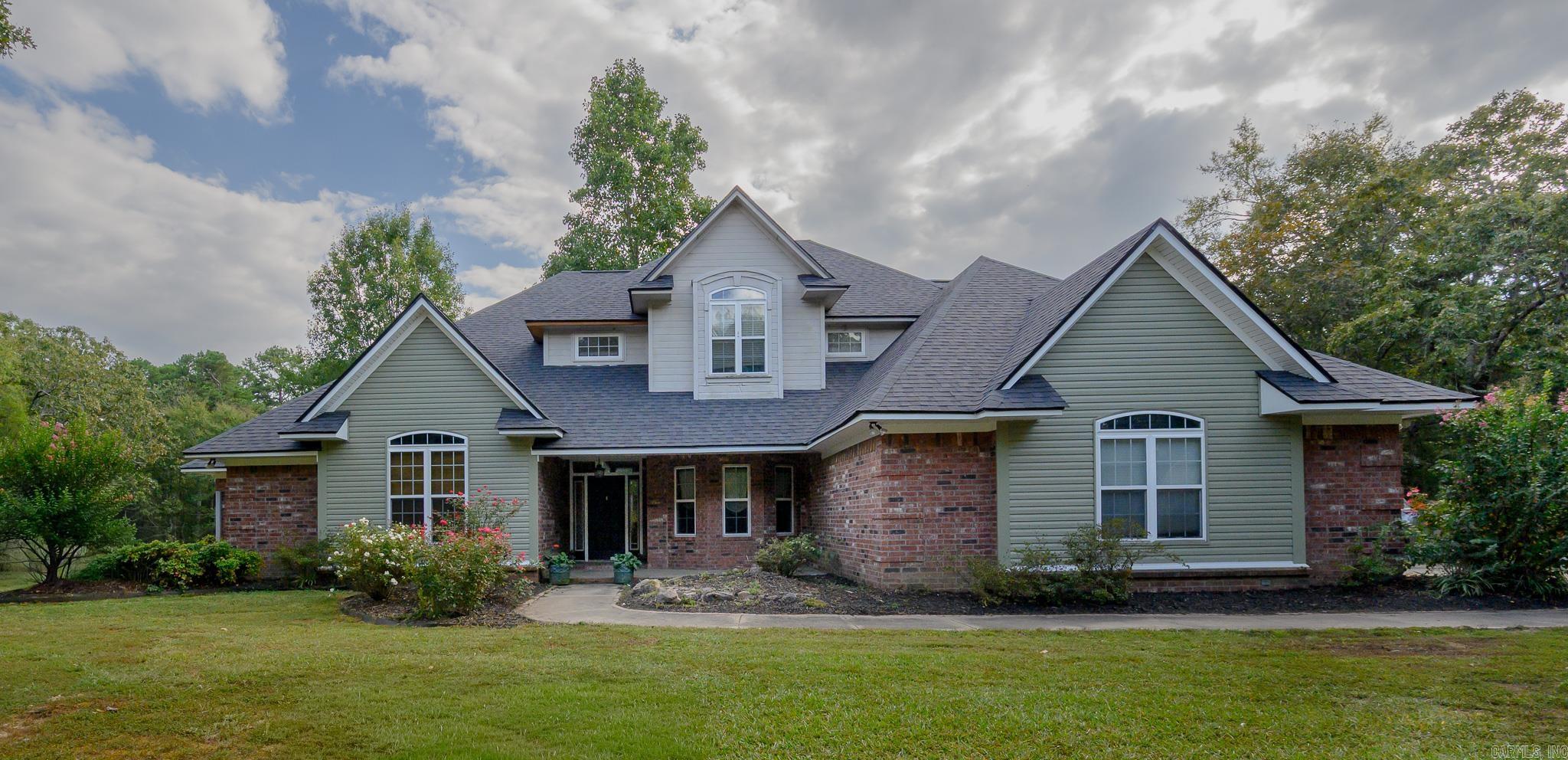 BEAUTIFUL home brimming with features and ideally located in the Mena Lake area! The home includes vaulted ceilings in the living room, open concept kitchen (complete with attractive cabinetry granite countertops, and stainless steel appliances), a lovely breakfast nook overlooking the fenced deck and POOL, & 2nd seating area with a gas fireplace! Primary suite is located on the 1st floor, including a walk in closet, double sinks in the bathroom, separate shower and jacuzzi tub! The 1st floor also includes a formal dining and separate office. The lofted 2nd floor has 3 spacious bedrooms, (two with a connecting Jack and Jill bathroom) and the other with its own en suite bathroom and built in desk & storage! There is ample additional storage throughout the home, large pantry, and a laundry room with a sink, countertops and storage cabinetry! Appliances new in the past 2 years including water heaters and AC units! New luxury vinyl on the main floor, & Brand New exterior siding and roof! Complete with 2 car garage, additional 1 car garage that could be used as a shop AND a FEMA approved storm shelter! All this sits on over 2 acres! A private oasis just minutes from town!