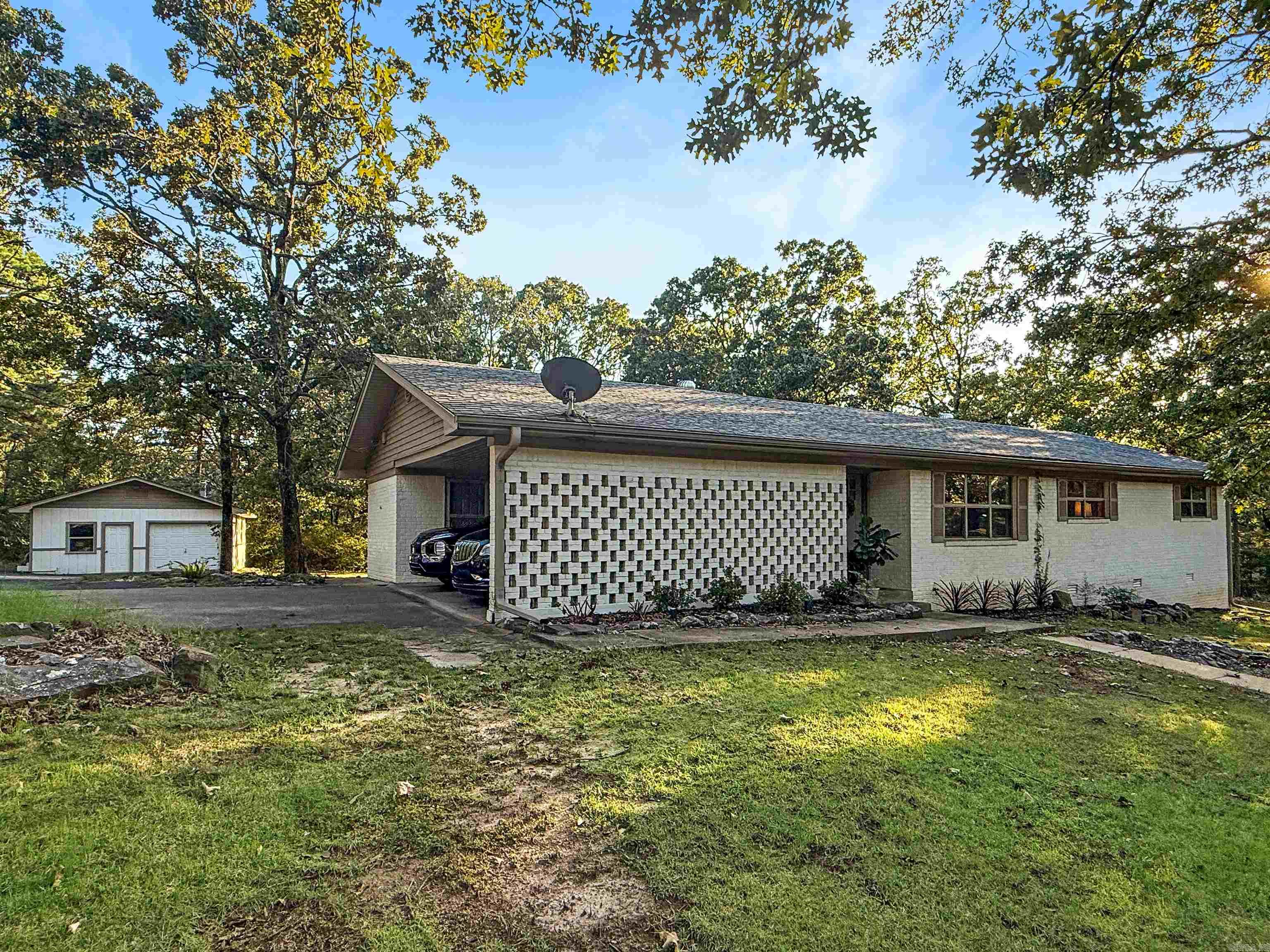 Welcome to this peaceful retreat in Conway’s Lakeview Acres. Nestled on 1.46 acres, this beautifully updated 3-bed, 2-bath home with office combines comfort, style, and function. Inside you’ll find Pella windows, fresh finishes, large walk-in closets, and a bright open layout that makes daily living easy. A standout feature is the 900 sq ft powered shop—perfect for hobbies, storage, or creative projects and a deck that provides breathtaking sunset views. Despite its tucked-away feel, you’re just minutes from the best of Conway. Enjoy downtown dining, coffee shops, and boutiques, plus convenient shopping at Conway Commons and Lewis Crossing. Outdoor lovers will appreciate Cadron Settlement Park with scenic trails and river overlooks, along with Beaverfork Lake for fishing, kayaking, and boating. Blending space, privacy, and location, this property is truly a rare find—schedule your showing today! Roof is 7 years old, HVAC replaced in Fall 2024, and water heater replaced in July 2025.