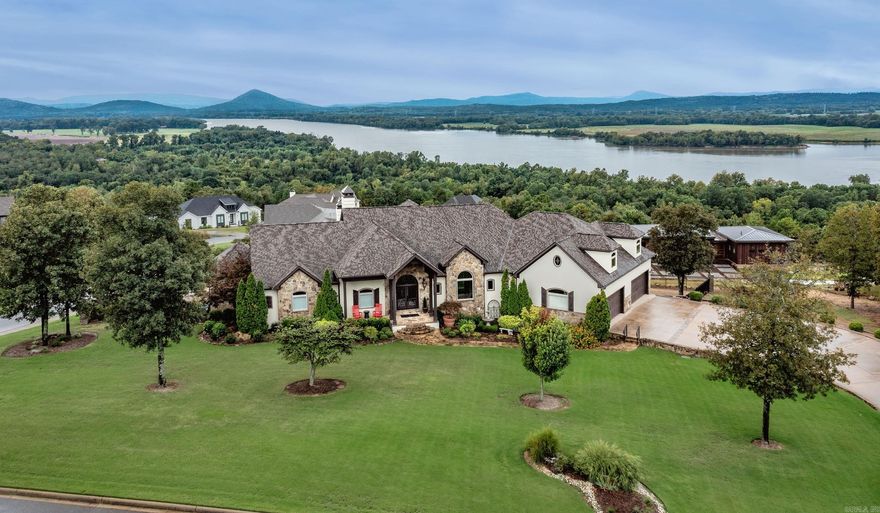 Luxury, Light & Unmatched Views on 1.5 acres. A masterpiece overlooking the Arkansas River and Pinnacle Mountain, this residence is a rare blend of architectural beauty, modern comfort and elevated outdoor living. Designed with intention at every turn, this home showcases soaring ceilings, curated finishes and walls of glass that frame unforgettable views. From the dramatic stone fireplace and chef's kitchen inside to the expansive beautiful deck with stone fireplace outside, resort style pool, hot tub and outdoor kitchen. Every space delivers a sense of escape without ever leaving home.  The lower level expands the lifestyle possibilities with a full second kitchen, guest suite, office, wine celler, workout room and enclosed sunroom with independent climate control making it ideal for multigenerational living, private guest quarters or inlaw suite.  Set on 1.51 meticulously landscaped acres within a gated community and equipped with luxury amenities including an elevator, whole-home generator, 3 fireplaces, custom cabinetry, extensive storage, 4+ car garage with a 1,200 sq ft floored attic. This home is built for comfort, security and timeless appeal.  Professional Pictures coming