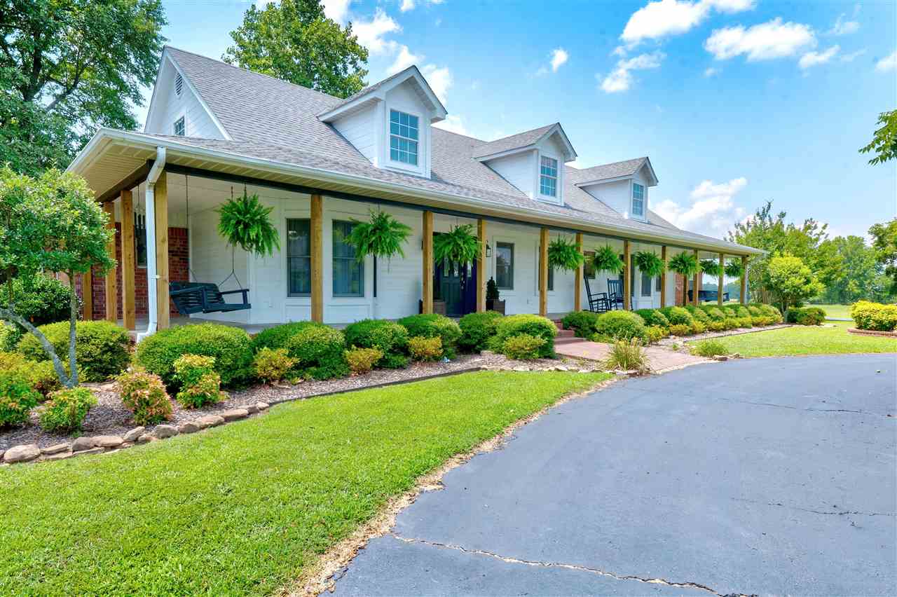 Breathtaking home outside and inside. Drive up the circle drive to the beautiful inviting porch lined with hanging ferns. Enter through the front door to a large & spacious living room & kitchen. Check out the master suite & gorgeous master bath & walk-in closets. Entire home has been remodeled with all the fine interiors to include granite counters, appliances to flooring & so much more. Additional 25x17 bunkhouse/storage w/plumbing. Acreage is beautiful & includes 2 ponds, AND MINERAL RIGHTS DO CONVEY!