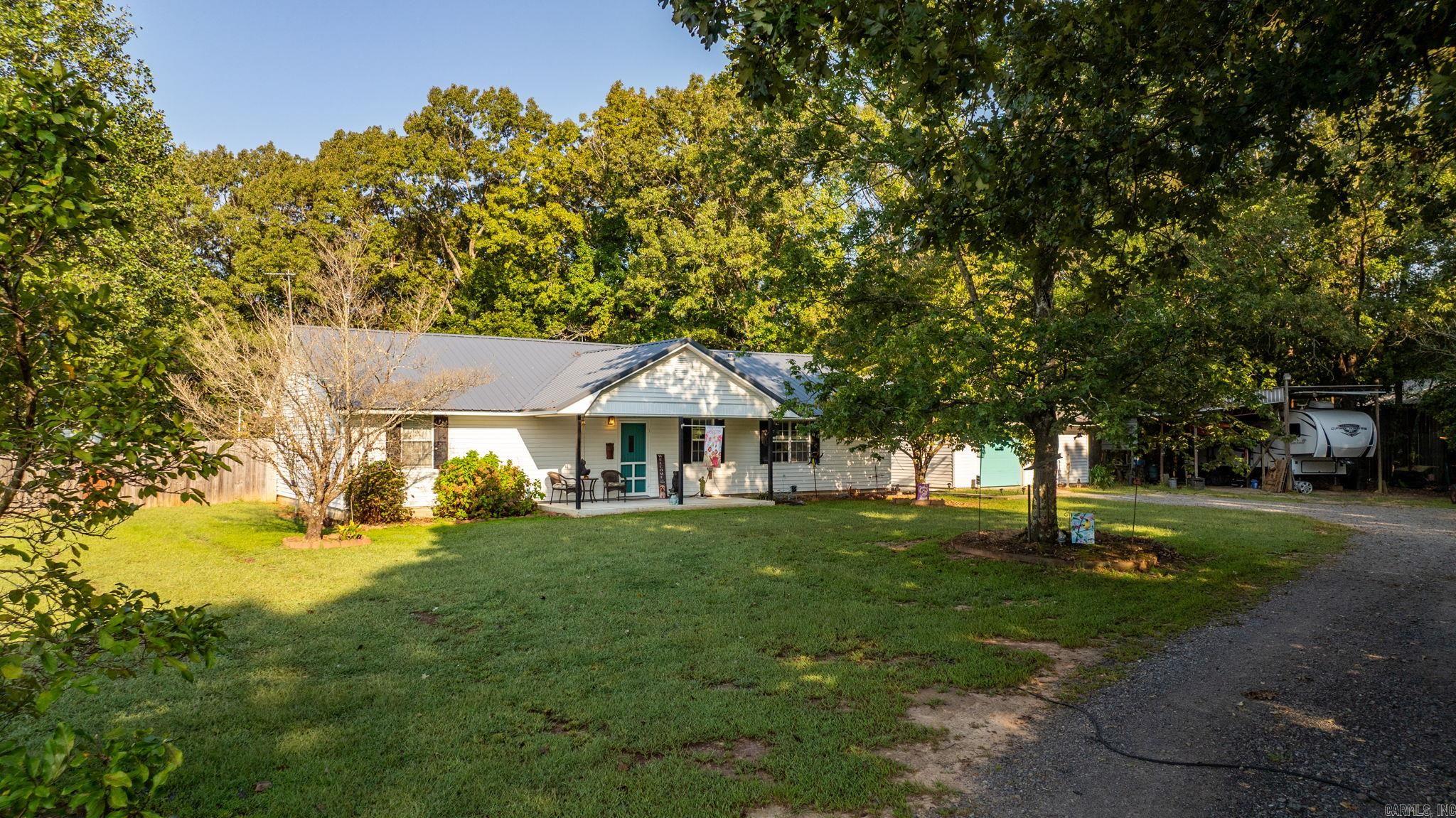 Escape to your own slice of secluded paradise with this 27 acre mostly wooded property perfect for hunting, recreation or peaceful living. This home is tucked away in the trees which offers privacy and plenty of space to roam. This beautiful home has been remodeled and is in excellent condition. Large kitchen with granite and wood countertops. Very large pantry and a fabulous laundry room as well. This home even has an office. HVAC 2021 Metal Roof 2023. Water heater 60 gallon. Looking for a shop this home has that too! 24' by 30' concrete floor 220 power. 10 foot lean to on the back of shop. Separate 24 by 24 garage with auto garage door opener. RV carport with power. Can't forget to mention the 14 by 16 insulated she shed in the backyard with air conditioning! The Murphy bed in the second bedroom will convey. Fully fenced backyard. It has public water but there is also a well that can be revamped to use if you wish. There are so many great features to this property you won't want to miss it. Homes with this much land in Greenbrier don't come along very often. Schedule a showing today!