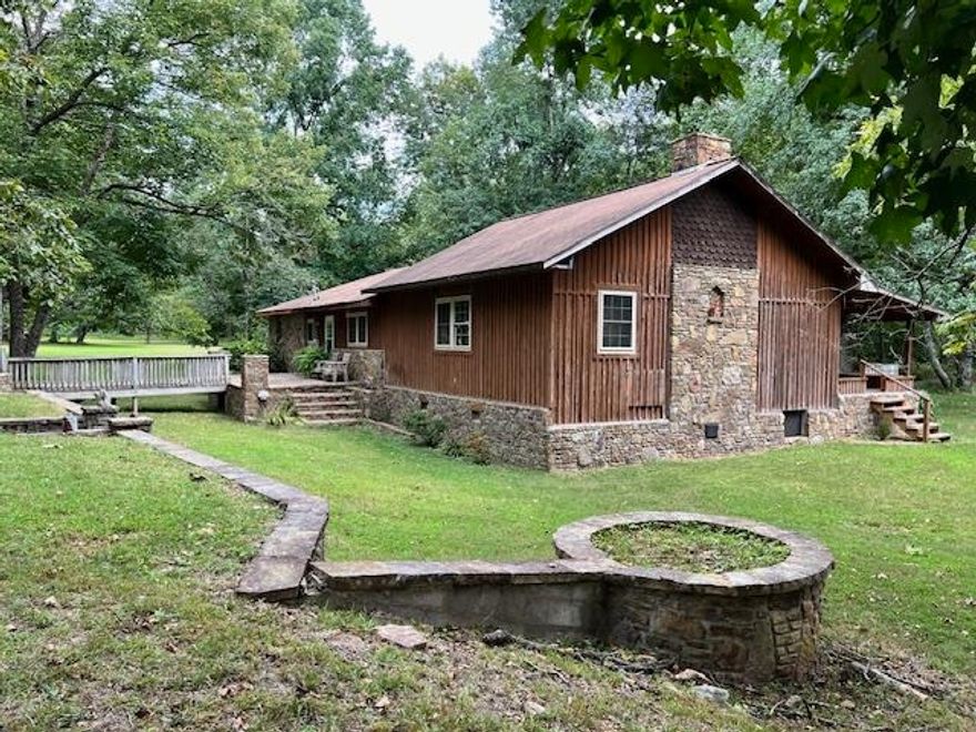 Step into a hunter’s haven and homesteader’s paradise with this Rustic 1,917 sqft retreat on 20 acres in Mountain View. Built in 1996, the highlight of this home is the expansive family room, featuring vaulted ceilings perfect for showcasing your trophies or enjoying downtime with family and friends. For the hunters, it includes a built-in gun rack cabinet and a bar—ideal for post-adventure gatherings. For the homesteader, the versatile acreage offers endless possibilities. Enjoy the stone outdoor cooking fireplace kitchen with waterfall, a deck for an above-ground pool, a large pond with a pier, and a spacious workshop for all your projects and equipment.  For women seeking a retreat within the retreat, the large main bathroom is an escape in and of itself, featuring a luxurious soaking tub and a custom walk-in shower. A creek across the road enhances the natural beauty. There is so much to see and take in on this vast property, that you have to view in person. Come experience peace, privacy, and abundant wildlife (deer and turkey)—this is your chance to create the lifestyle you’ve always dreamed of in the Ozark Mountains!