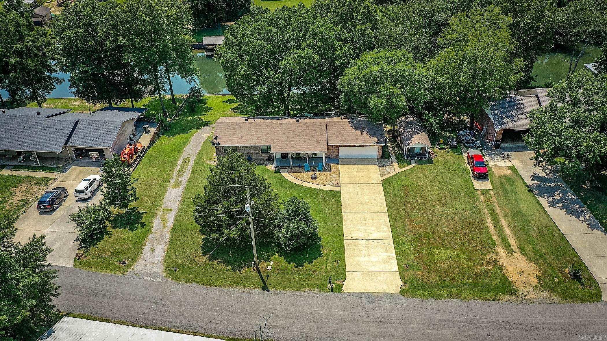 Lakefront home offering 4 bedrooms, 3 bathrooms, and just under approximately 2,400 sqft of comfortable living space with beautiful water views just minutes away from all the amenities of Hot Springs. The main level features open living and dining areas filled with natural light, while the lower level includes a separate living space with its own entrance and private driveway—perfect for guests, extended family, or potential rental income. With around 140' of lake frontage, enjoy direct access to the lake for swimming, boating, or relaxing by the water. The outdoor spaces are ideal for entertaining or quiet evenings by the lake. Whether you're seeking a full-time residence, weekend retreat, or investment property, this home offers year-round enjoyment in a peaceful natural setting fitting to the lake-living lifestyle. A rare opportunity to own a versatile waterfront property.