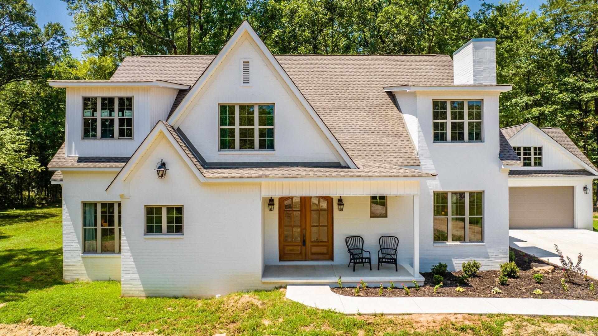 Gorgeous custom-built home in Faulkner County on 2.2 acres just minutes from downtown Conway. Home was built for large family so the floorplan is perfect giving each of the 4 BRs a bath, and a walk-in closet with built-ins. There is also a gameroom for the kids upstairs. Two BRs including master are on main level and 2 BRs upstairs. There are closets and storage galore! The main level features an open area for the kitchen and living room. Kitchen has a large breakfast bar, six burner gas stove, pantry, coffee bar, appliance area for mixers, etc. and large refrigerator. FP in the living room. So many windows in every room to enjoy the outdoors. Covered patio has a FP, big screen TV, eating area and ceiling fans. There is a tankless water heater, staircase to the attic in the garage. There are so many unique features in this home, you will have to take a look to appreciate them. There is a creek on the property, a 1000 gal septic tank and drain lines across the front of the property to divert any rain water away from the house. Land is mostly level. Yardwork in the front is not complete yet.