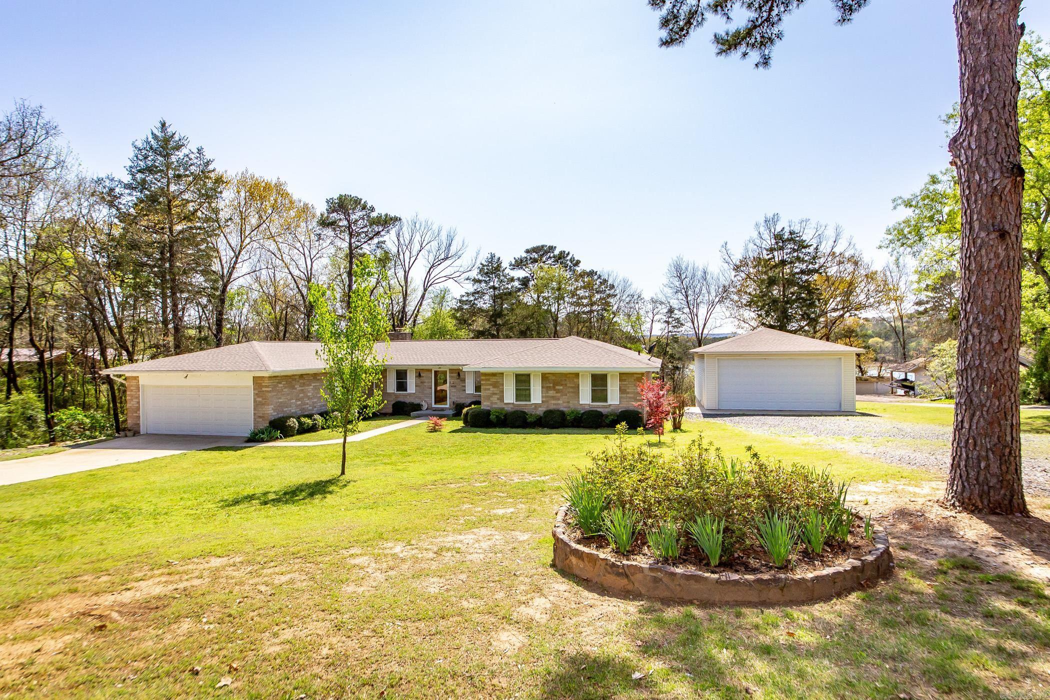 This beautiful, well-kept home is one level with a walkout finished basement and on the water! Located in the tranquil, sought-after subdivision of Interlochen Estates in the heart of Greers Ferry Lake. Close to town and three local marinas! No need for paying for boat storage with the additional detached shop was built 4 years ago and large enough for all your toys! This 3 bed, 2 1/2 bath home has an attached two-car garage and many updates, including granite countertops in the open kitchen and brand new quartz countertops & fixtures in the baths. The roof was replaced 4 years ago, and more recently, a new HVAC was installed. The electric cookstove has a gas line run to it already if that is your preference. The gentle slope and easy walking path make it easy to hop on the boat! Landscaping is developed and low maintenance. The fireplace in the main living area has had an update with new stone & tile. This home is a must see! Contact me today for your showing.