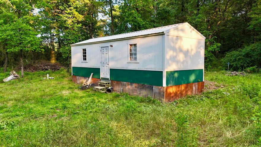Tucked away in the peaceful countryside, this 1-acre lot offers privacy, potential, and a rustic start to your dream retreat. The main 16' x 40' structure includes a studded 12' x 12' addition—perfect for customizing into your ideal getaway. Electric and water are already on site. With a little vision and effort, this property is ready to be transformed. Sold as is—bring your imagination and make it your own!