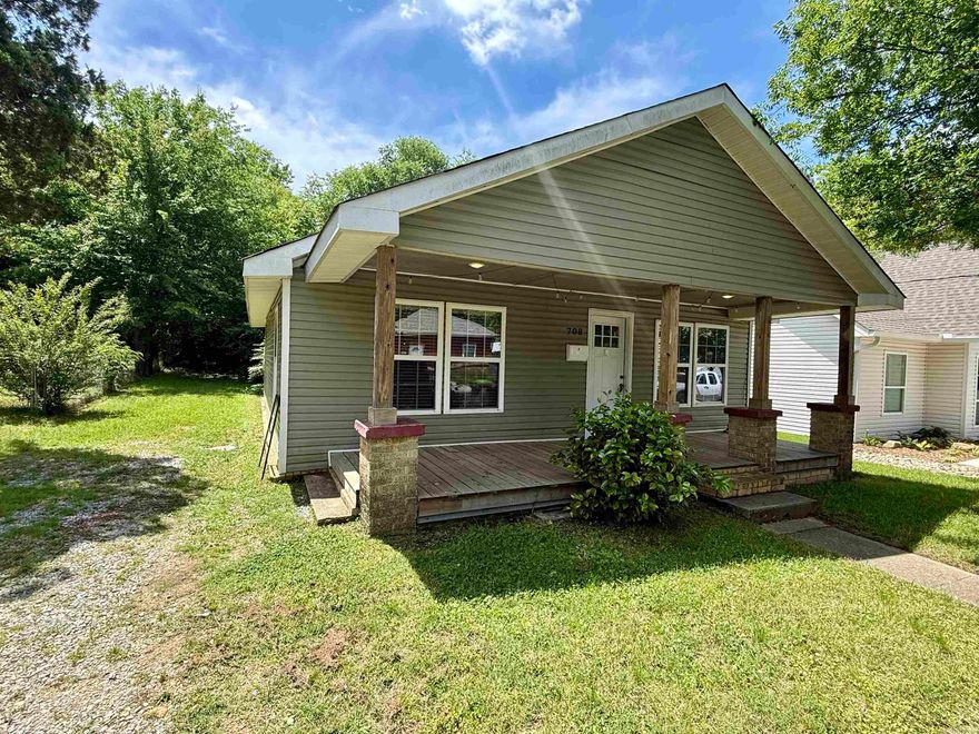 Nestled in the heart of downtown Benton, this fully remodeled two-bedroom, one-bathroom home offers a modern and luxurious living experience. The kitchen boasts granite countertops and luxury laminate throughout, complemented by the inclusion of a refrigerator, washer, and dryer in the conveyance. The new roof, HVAC system, plumbing, and electrical work were completed in 2021 and 2022. The spacious backyard and oversized front porch provide ample opportunities for outdoor living.