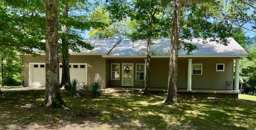 Nestled just minutes from both Henderson State University and Ouachita Baptist University, this 10-acre property offers a perfect blend of convenience and natural serenity. The well-kept 1-bedroom, 1-bathroom home sits on a gentle rise overlooking a beautiful 3-acre stocked pond—ideal for peaceful mornings or relaxing evenings on the back deck.  Designed with an open floor plan, the home feels spacious and inviting, with scenic views that bring the outdoors in. A portion of the garage has been thoughtfully converted into a large storage room, providing extra functionality without sacrificing space.