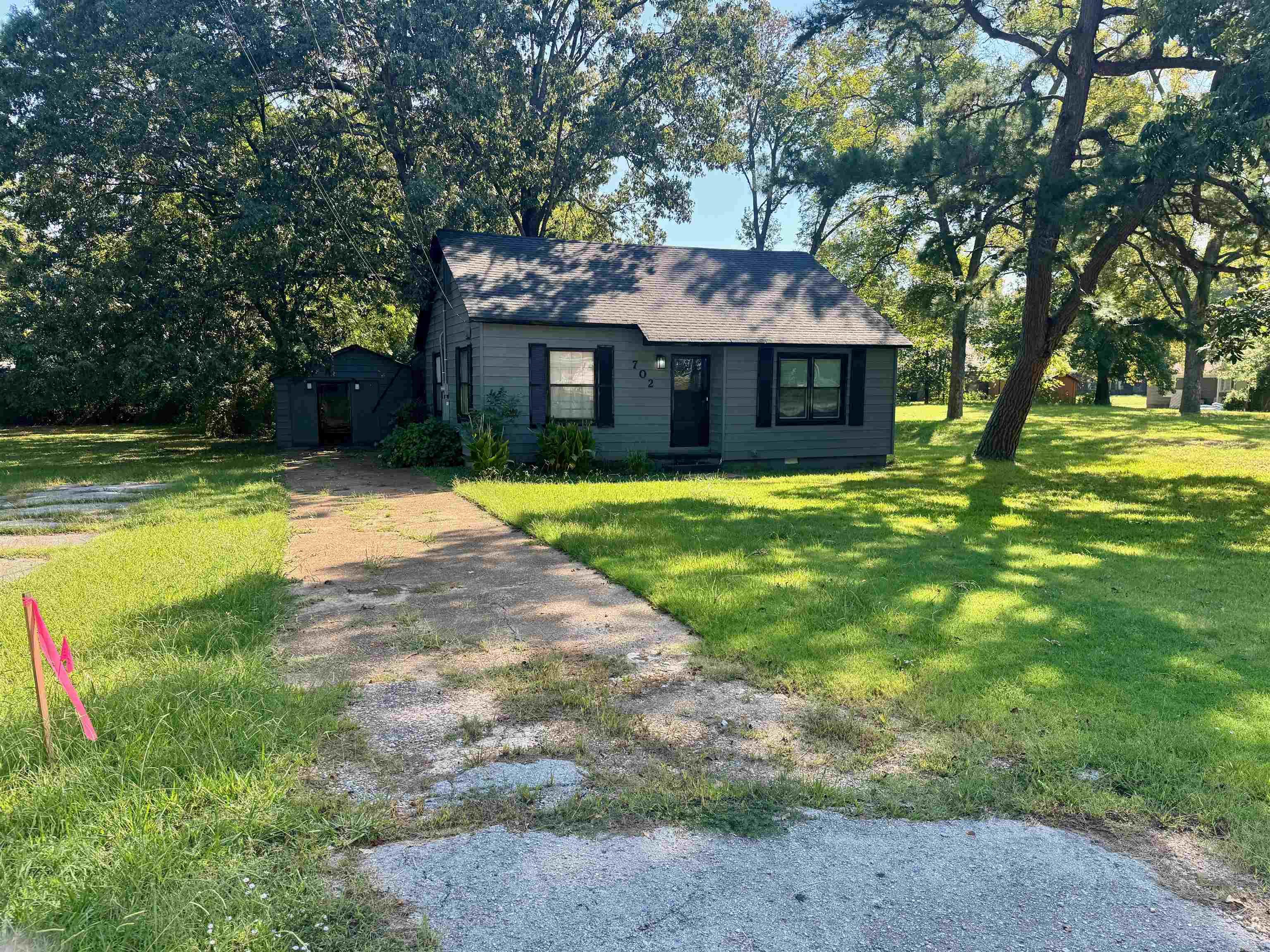 Check out this cute 2 bedroom 1 bath bungalow with a covered porch and a shop! The kitchen has newer white cabinets, granite countertops, and a stainless microwave & refrigerator! There is a spacious living room and a formal dining room with hardwood flooring. The bedrooms are big too. You will love the large shop and the 1/4 acre shaded lot with pecan tree. Walking distance to Native Brewery. Home has 2 gas wall hung heaters as a backup heat source and a large laundry/mud room. Sold AS IS