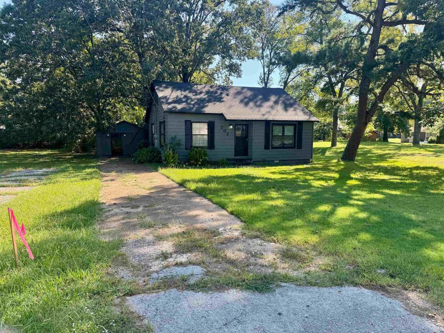 Check out this cute 2 bedroom 1 bath bungalow with a covered porch and a shop! The kitchen has newer white cabinets, granite countertops, and a stainless microwave & refrigerator! There is a spacious living room and a formal dining room with hardwood flooring. The bedrooms are big too.  You will love the large shop and the 1/4 acre shaded lot with pecan tree. Walking distance to Native Brewery.  Home has 2 gas wall hung heaters as a backup heat source and a large laundry/mud room. Sold AS IS
