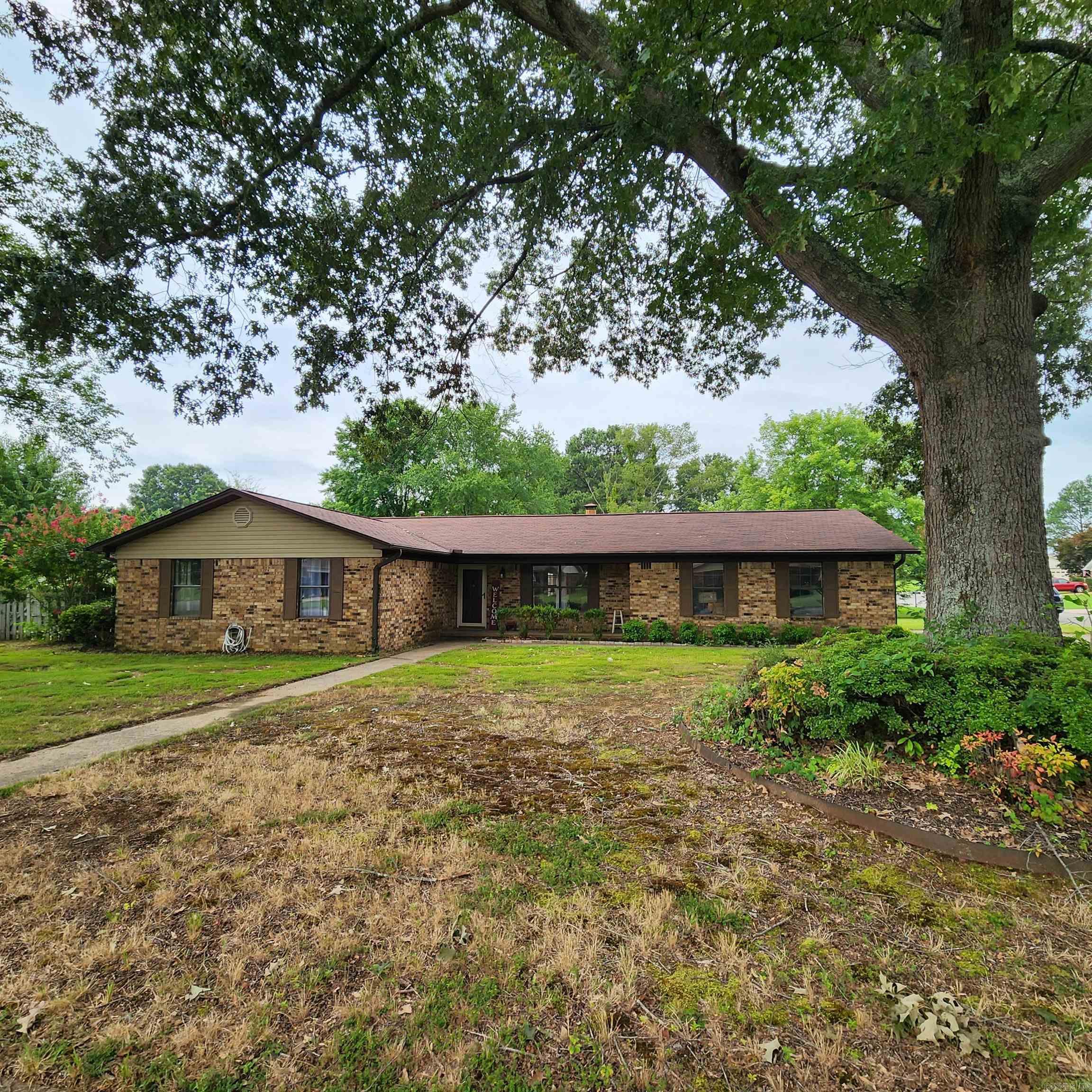 Nice brick house with side load garage on a corner lot in established neighborhood. This 3 bed, 2 bath home features an open floorplan with separate dining area, breakfast bar, gas log fireplace, spacious separate laundry with attached mudroom for back door & garage access. There is a walk-in closet & bathroom off large main bedroom. New Heat & Air was installed one year ago, so it will be under warranty for almost 4 years. Recently remodel also include new wood laminate flooring in living room, ceramic tile in kitchen, mudroom & laundry. Newer appliances & neutral paint. The back yard is fenced with shade & storage building. There is a covered patio for grilling & relaxing. Appointment only, please see agent remarks.