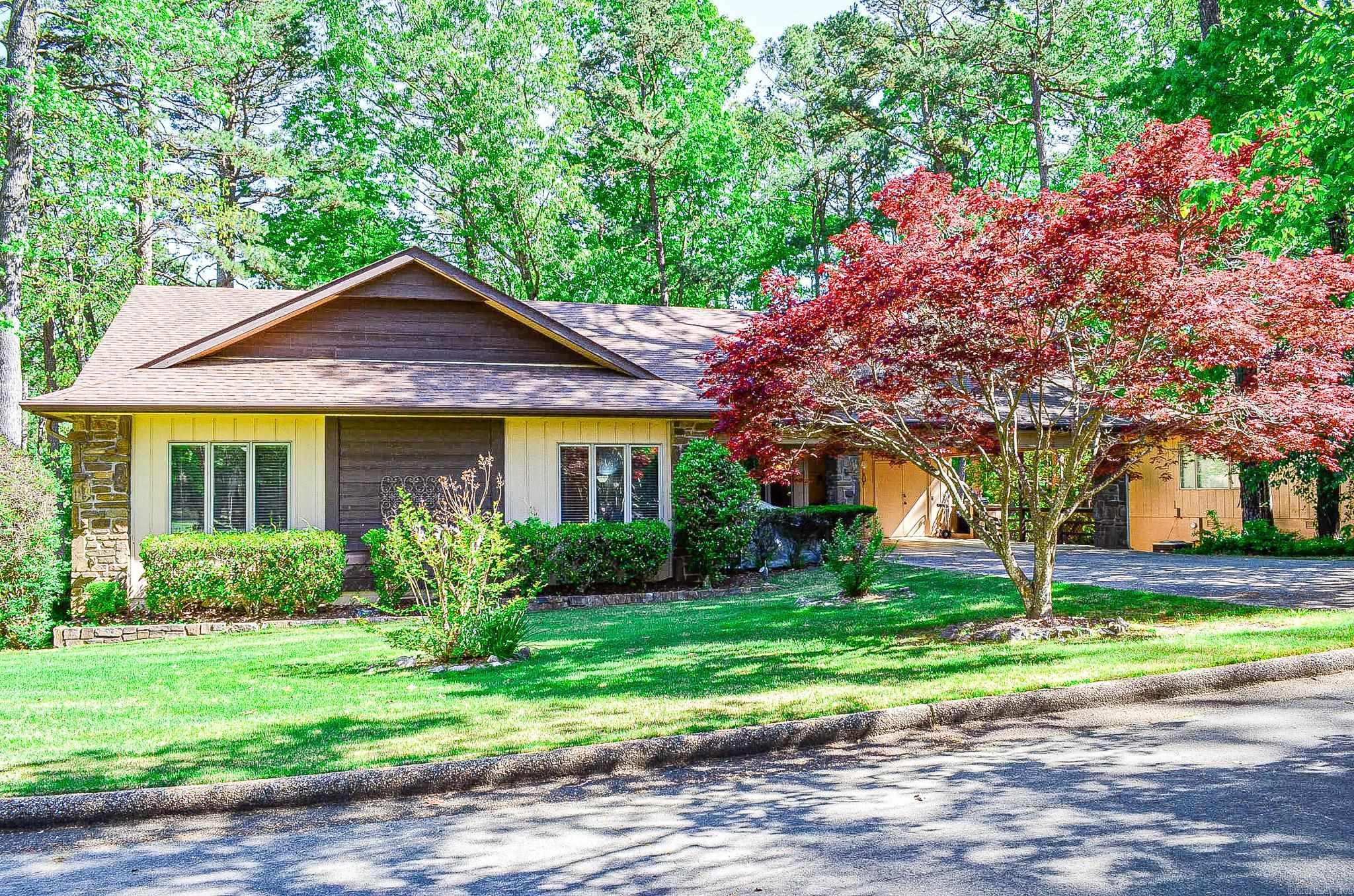 Discover the perfect blend of comfort and style in this immaculately maintained standalone townhome located on a desirable corner lot. This home boasts 3 bedrooms and 2 baths, featuring a spacious owner's suite with a walk-in closet, a luxurious step-in shower, and double vanities for added convenience. The open-plan living and dining area is enhanced by elegant coffered ceilings and a picturesque bay window that floods the space with natural light. Central to the living room is a stunning natural stone wood-burning fireplace, adding a touch of warmth and charm. The kitchen is a chef's delight, equipped with solid surface countertops, a generous pantry, and tile running into the stylish LVP flooring that extends throughout the main areas. Just a short distance from the DeSoto Golf Course and driving range, this home is perfect for golf enthusiasts looking to enjoy quick access to facilities while residing in a tranquil community setting. Additional amenities include a separate laundry room, a two-car carport, open deck, and a level driveway, ensuring practicality meets sophistication. Agents kindly review agent remarks.