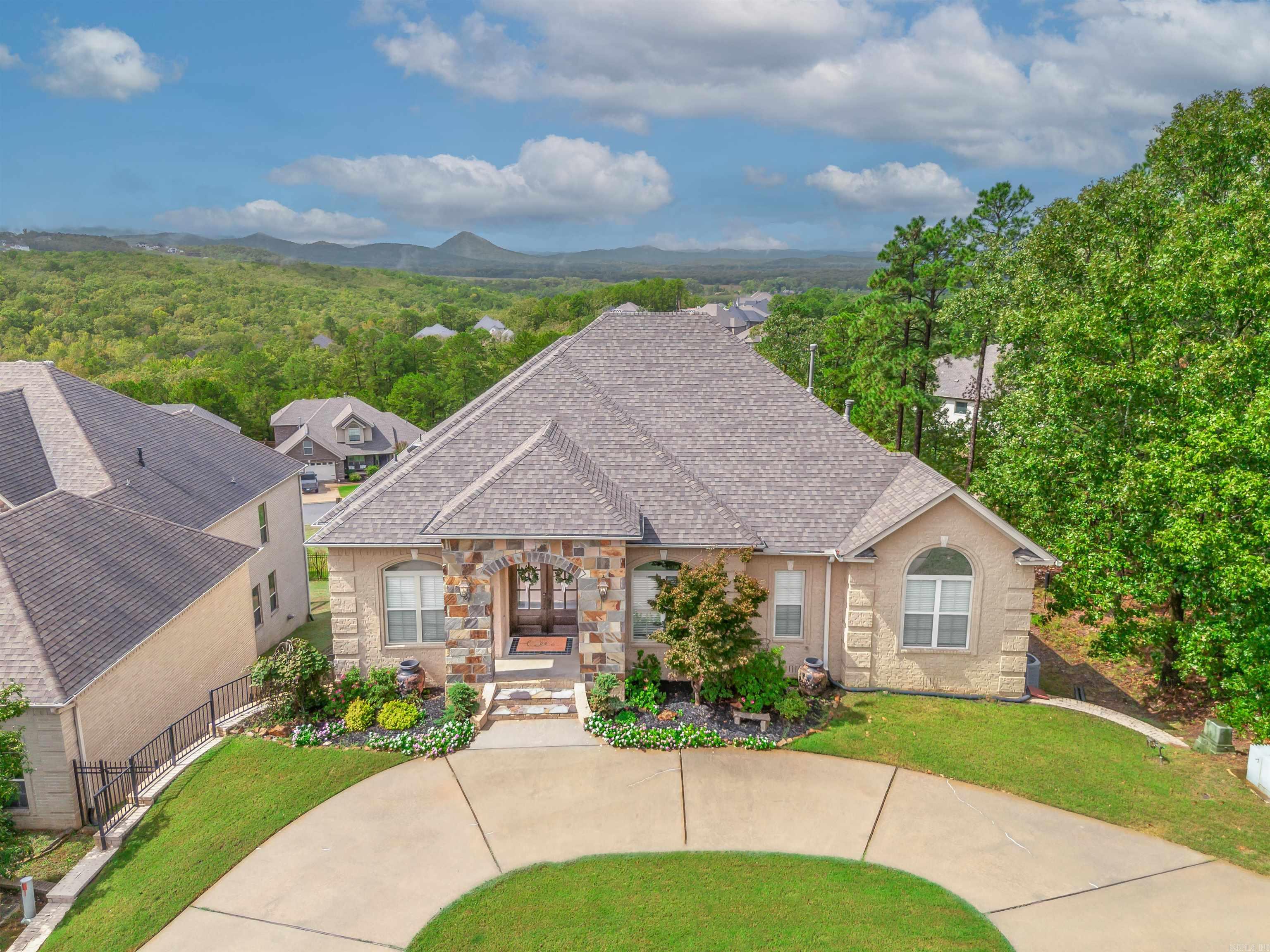 Majestic vista view of Pinnacle with spectacular sunsets from kitchen, all 3 living areas and primary bedroom. Flexible floor plan for large family or in-law qtrs downstairs with large bonus/family room, 3 BR and 2 full baths(one ensuite). Main level features large living room plus a huge open concept hearth room with eat in kitchen including breakfast bar, separate dry/coffee bar and pantry plus a large laundry room with lots of storage. Gourmet kitchen equipped with gas stove top, double ovens, bev. cooler, fridge, disposal, and dishwasher. Separate dining room (currently being used as office) is also located on main floor as well as a bedroom and full bath in addition to the primary BR suite. There are two new covered decks, (upper and lower),a fully enclosed iron fence in the back yard, new roof and most of the interior has been painted recently.Tankless water heater. You must see this beautiful home to fully appreciate all the extras...and the VIEW is indescribable. Book a showing today! See agent remarks