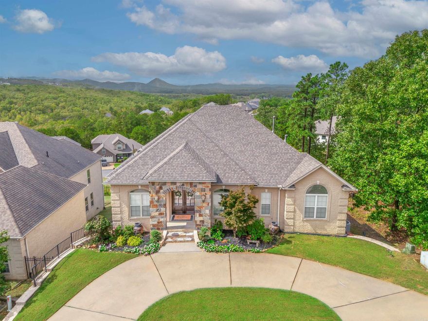 Majestic vista view of Pinnacle with spectacular sunsets from kitchen, all 3 living areas and primary bedroom. Flexible floor plan for large family or in-law qtrs downstairs with large bonus/family room, 3 BR and 2 full baths(one ensuite). Main level features large living room plus a huge open concept hearth room with eat in kitchen including breakfast bar, separate dry/coffee bar and pantry plus a large laundry room with lots of storage.  Gourmet kitchen equipped with gas stove top, double ovens, bev. cooler, fridge, disposal, and dishwasher. Separate dining room (currently being used as office) is also located on main floor as well as a bedroom and full bath in addition to the primary BR suite. There are two new covered decks, (upper and lower),a fully enclosed iron fence in the back yard, new roof and most of the interior has been painted recently.Tankless water heater.  You must see this beautiful home to fully appreciate all the extras...and the VIEW is indescribable. Book a showing today! See agent remarks