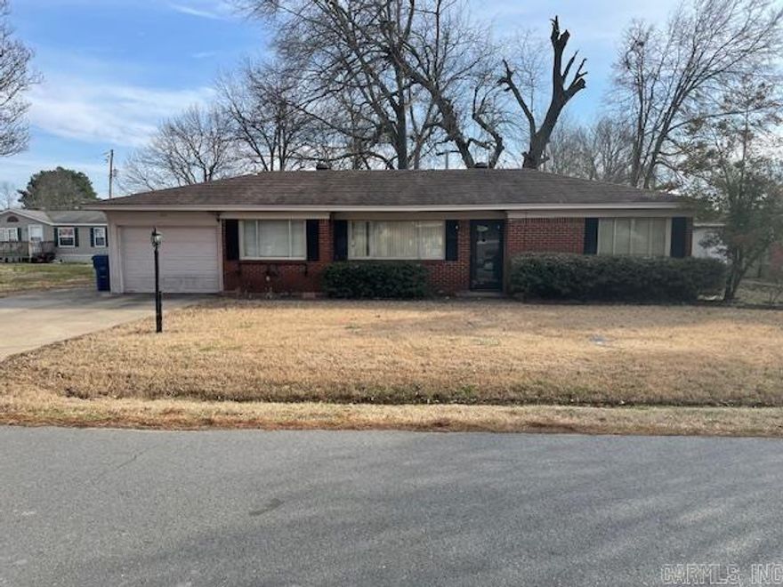 Nice brick home next door to the elementary school. Huge back yard with privacy fence. Home has been updated. Living area is very open. New paint throughout. Garage with garage door opener.