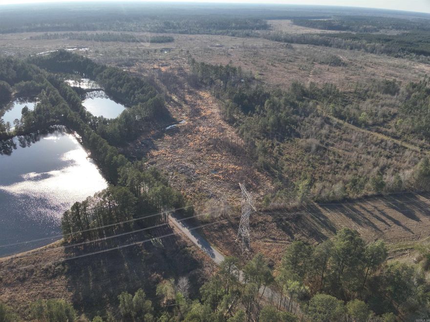 Located in rural Calhoun County, Arkansas, the Calhoun CR 26 North Tract offers a great combination of recreational opportunity, timber investment, and rural accessibility. The property features paved county road frontage, providing reliable year-round access and make it a convenient location for a homesite, hunting retreat, or investment property.  Calhoun CR 7 forms the southern boundary of the tract, adding additional access and a clearly defined boundary. One of the standout features of the property is the presence of two ponds created from old gravel pits, which provide excellent fishing opportunities and add to the recreational appeal of the land.  Approximately 22 acres of the property are a 5-year-old pine plantation, offering future timber income potential while also providing wildlife habitat.  The mixture of ponds and young timber create a great environment for the outdoor enthusiast!   The property is located within the Hampton School district making it an attractive option for families looking for rural land with nearby school access.