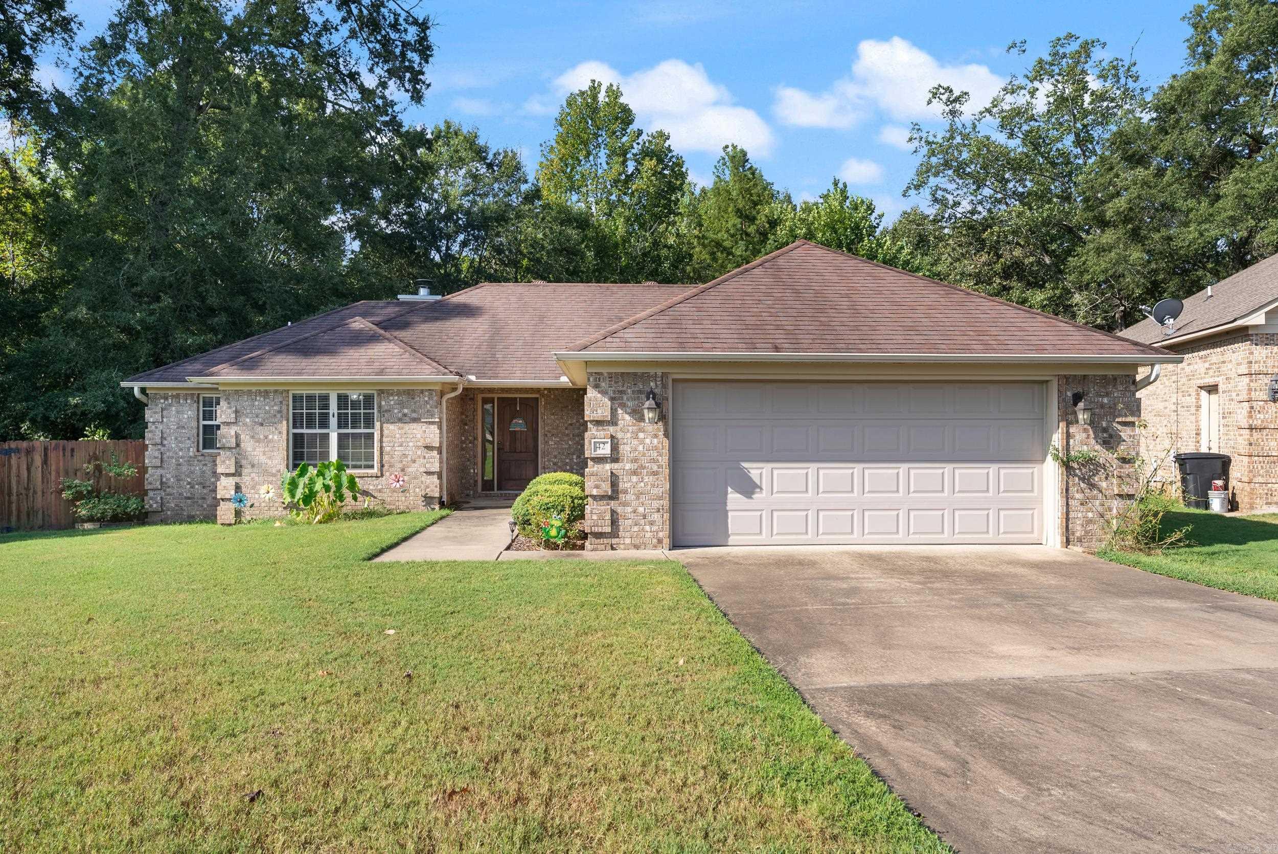 Welcome to this inviting home featuring a private, fully fenced backyard surrounded by mature trees-perfect for relaxing or entertaining on the large deck. Inside the layout offers ideal separation with the primary bedroom apart from the guest bedrooms. The kitchen includes a bar top ideal for casual dining or hosting. The cozy living room is highlighted by a woodburning fireplace. The primary bathroom has a walk in shower and a bathtub. You will enjoy having the space with 2 separate closets. The garage has an entertainment area that includes a sink, tv and a countertop or this space could be used for extra storage. This home combines comfort, functionality and outdoor living space all in one.