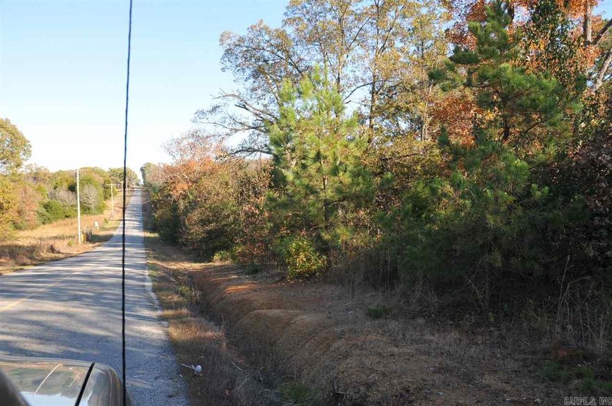 Wooded acreage with lots of footage on Hwy 16.  Includes approx. 3 acre pond.  Property is currently being taxed with other adjacent property, so taxes to be determined once parcels are divided. Almost 900 feet of Highway frontage, and approx 1500 frontage on Johnston.