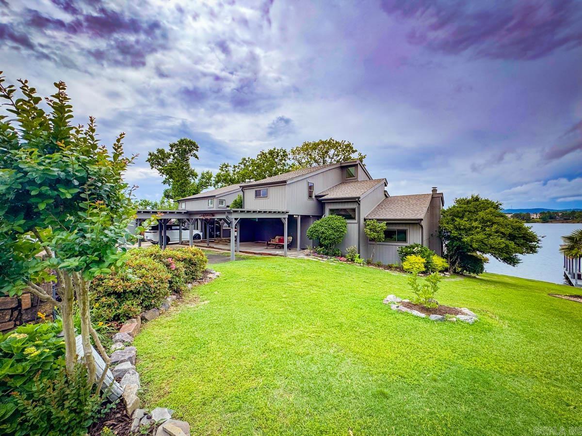 You have to see this completely updated condo in Long Island Bay off Hwy 7S on the main channel of Lake Hamilton in a gated subdivision, with a gorgeous view of the sunrise and sunset. It features a large front side and back yard where you can watch the eagles soar and all the lake activity from your kitchen, or upper and lower decks! It has all new interior and exterior paint, new roof, one new AC unit and digital thermostat, new ice maker, freshly remodeled kitchen with gas range and below counter microwave. There is an office space/storage area adjoining one of the upstairs bedrooms. Real hardwood flooring throughout. Gas fireplace. Comes with a one stall boat dock and lift. Includes a community pool and gazebo, two car carport, and a storage room off the carport.
