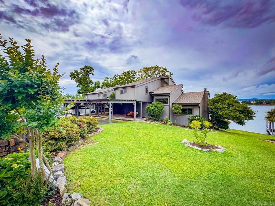 You have to see this completely updated condo in Long Island Bay off Hwy 7S on the main channel of Lake Hamilton in a gated subdivision, with a gorgeous view of the sunrise and sunset. It features a large front side and back yard where you can  watch the eagles soar and all the lake activity from your kitchen, or upper and lower decks! It has all new interior and exterior paint, new roof, one new AC unit and digital thermostat, new ice maker, freshly remodeled kitchen with gas range and below counter microwave. There is an office space/storage area adjoining one of the upstairs bedrooms. Real hardwood flooring throughout. Gas fireplace. Comes with a one stall boat dock and lift. Includes a community pool and gazebo, two car carport, and a storage room off the carport.