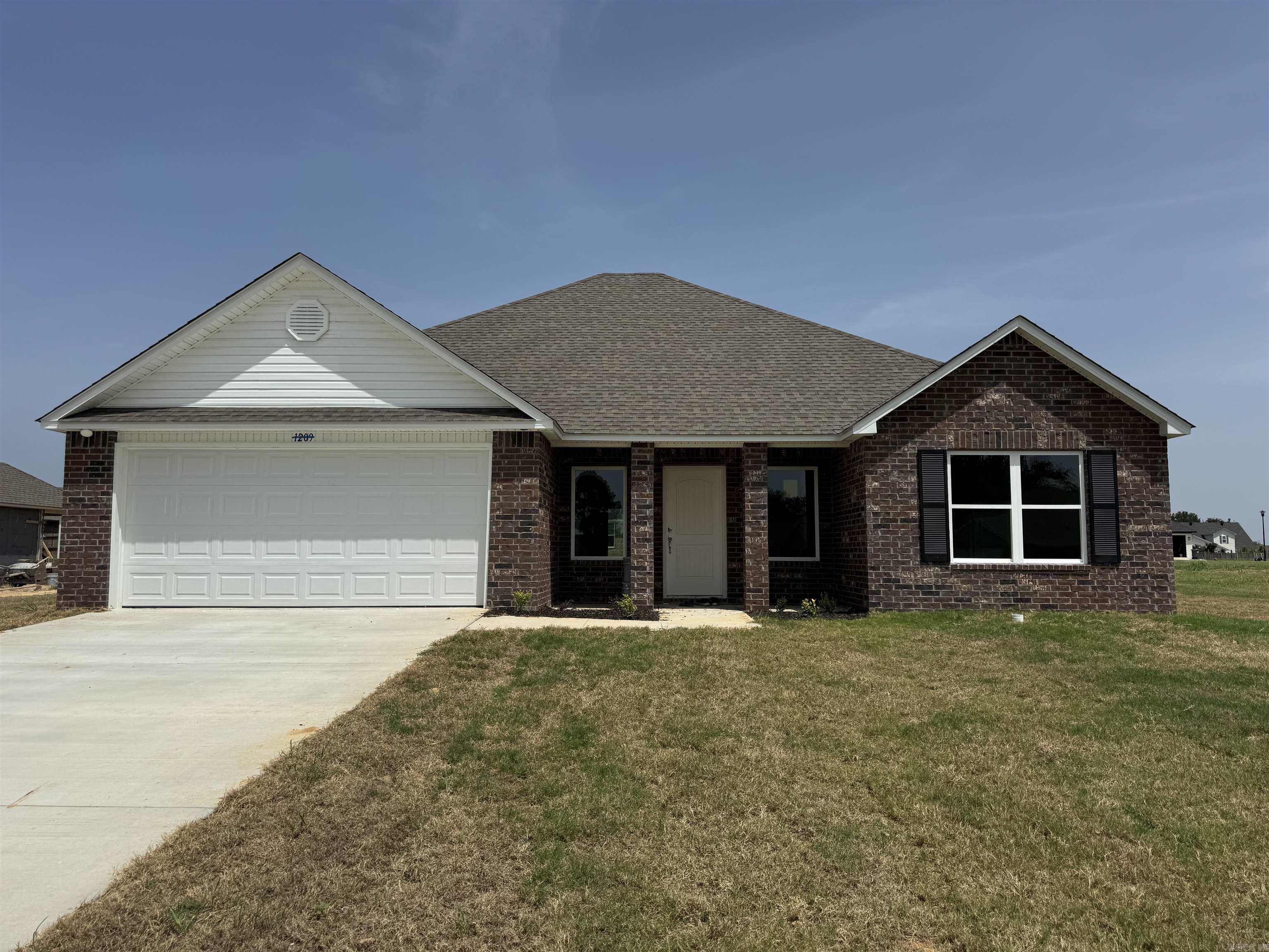 Washington plan corner lot oversized lot Upgrades: sides brick on home, 14'x10' covered patio with architectural shingles, 8/12 roof with architectural shingles, both toilets upgraded to elongated, plumbing faucet upgrade 2, 8" deep Kitchen sink, 50 gallon water heater, HVAC rigid duct upgrade, crown on Kitchen cabinets, cabinet hardware level 1, 16" laminate bar top in Kitchen, Luxury Vinyl Plank flooring in wet areas and Living Room and adjacent hallways and all Bedrooms including closets, arched entries, raised ceilings in Living Areas per municipal requirements, front door handle upgrade to lever, fiberglass exterior doors, Cheyenne style doors, baseboards level 2, LED disk lights in Kitchen, full sod, stainless steel appliance package, corner lot, oversized lot.