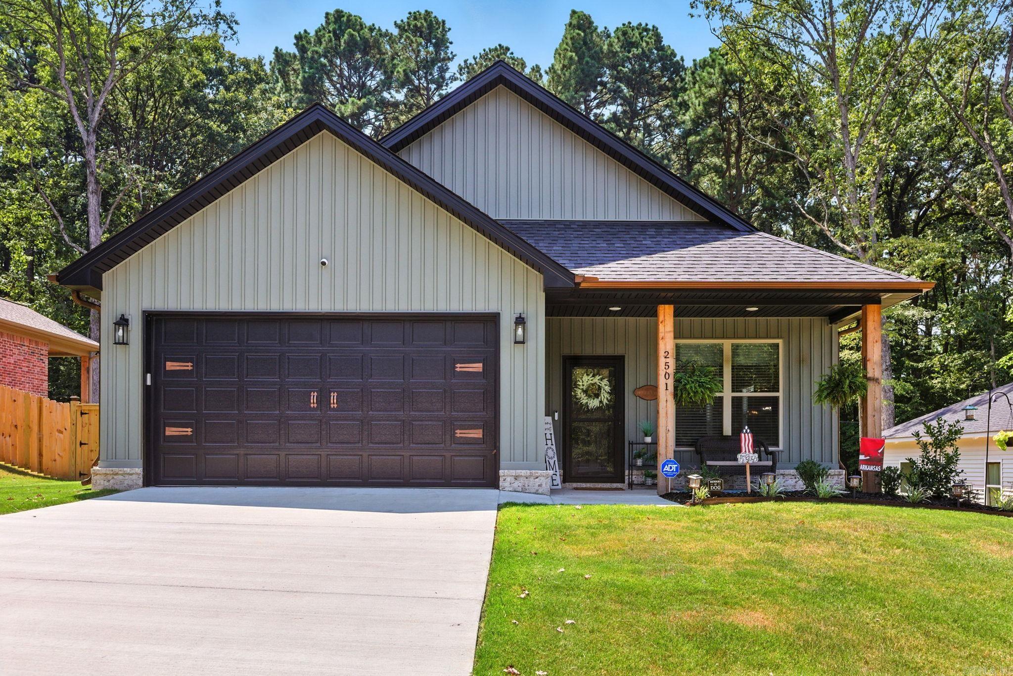 Built in 2025, this stunning home is perfectly situated in an established neighborhood, close to everything Benton has to offer. The open-concept kitchen features a spacious island, custom cabinetry, wood beam accents, and a spacious pantry—perfect for cooking and entertaining. The primary suite is a true retreat located in the back of the home with wood beams, a walk-in closet, and a spa-like bath with double sinks. Bedrooms are roomy and have built-ins in the closet space. Convenience meets function, with a laundry room and mud area just off the garage entrance. Additional highlights include LVT flooring in main areas, thoughtful custom finishes, copper guttering, and abundant natural light. Step outside to enjoy the covered front & the covered back patio overlooking a fully fenced backyard that backs up to peaceful green space. This home combines modern design with timeless charm—you won’t want to miss it!