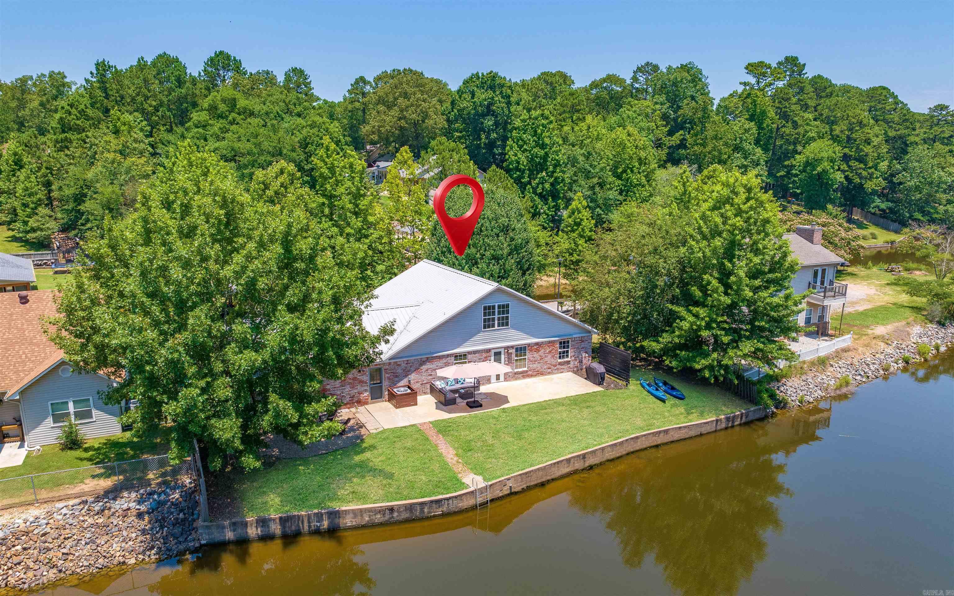 Perfect location for your full-time residence, weekender or investment property on the beautiful shores of Lake Hamilton. Currently operating as a short term rental. This property boasts a large living/dining area great for entertaining. The 3bed 2bath home with loft for extra beds is well maintained with new interior paint, lighting fixtures, cabinet pulls, landscaping and a new floating 6x28 dock. Enjoy relaxing lakeside by the stone fire pit, or take off on the water for all the boating fun on Lake Hamilton!