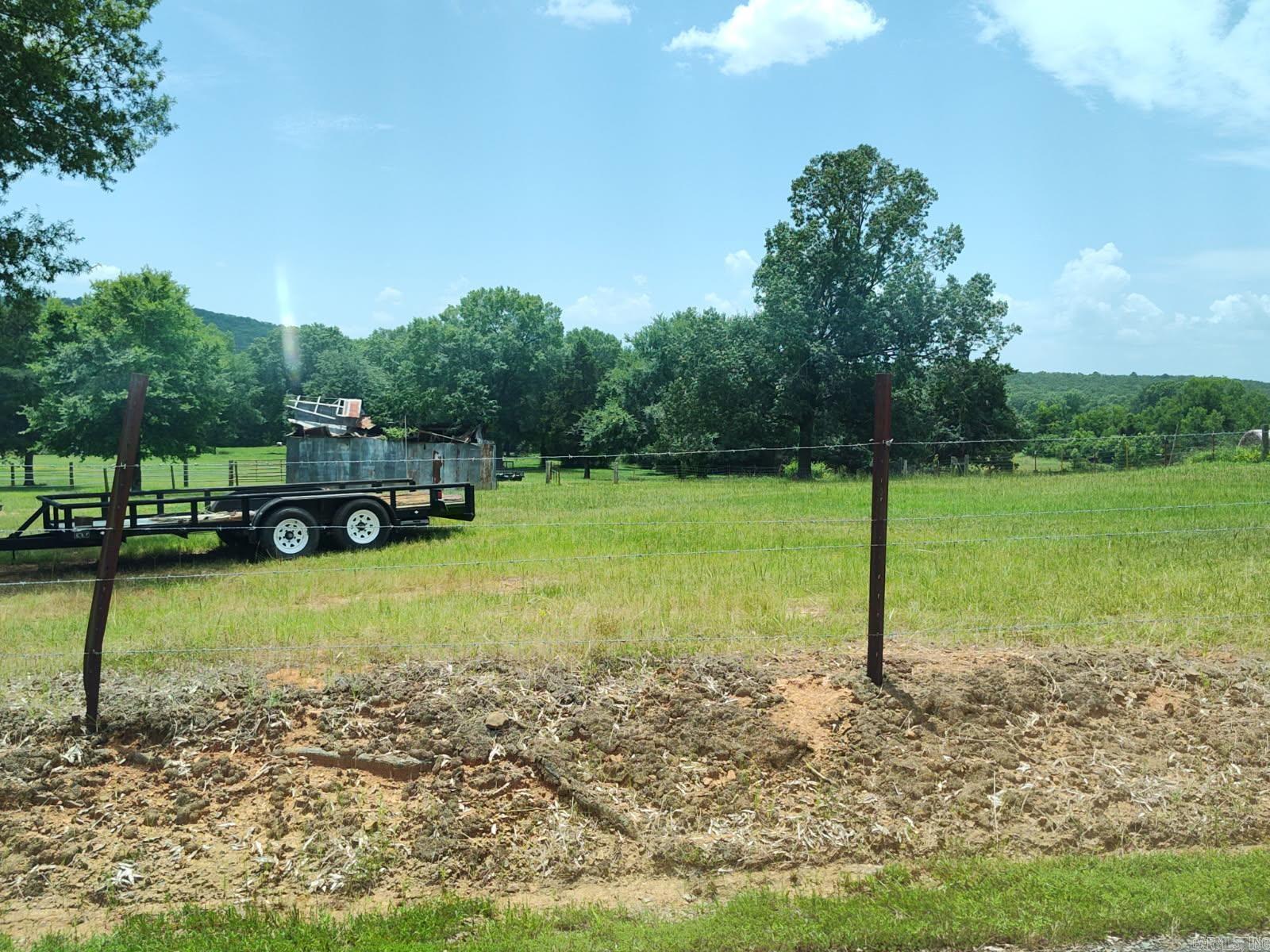 Unrestricted almost 10-acre lot. Suitable for a home, manufactured home, or livestock. Partially cleared. About 2 acres of pasture and 3 acres of timber. 3.5 miles from Conway. Adjacent lot is also for sale