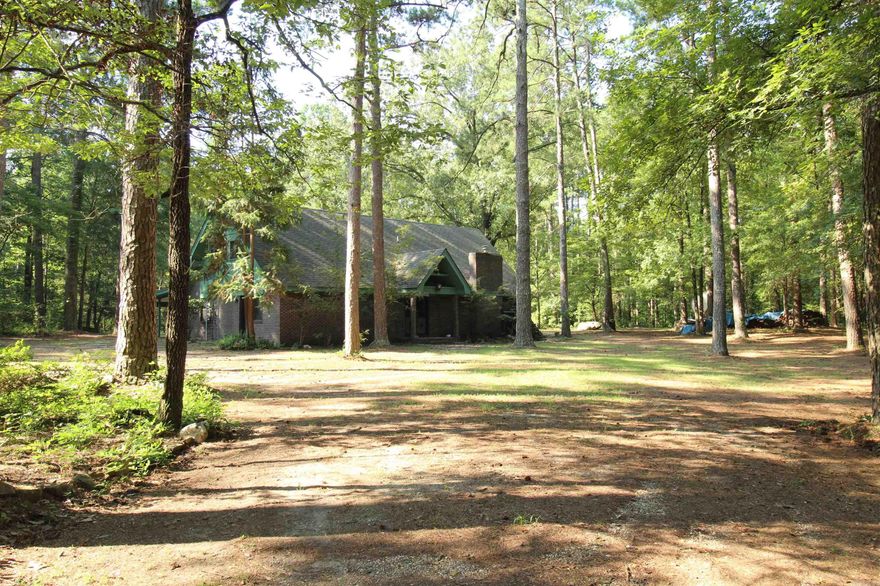17.5 acres with almost $65,000 worth of timber included in only $152 a square foot*original owner home*all brick*pond*native stone stairs and walkway by pond*small shop*25 foot vaulted ceiling in HUGE living room*the wood beams on the ceiling were reclaimed from wildfires out west in 1974*licensed electrician and plumber just went all through the house-everything should be good to go*chimney cleaned*roof replaced with architectural shingles 9 years ago*smoke free home*master bedroom downstairs*tons of closets*two bedrooms are upstairs*office could be the fourth bedroom*enjoy the wildlife in this private oasis*some trees are over 200 years old*cherry, apple, pear, pecan, plum, persimmon, Japanese maples, paw paws, cypress and fig trees cover this beautiful land*needs updated but priced accordingly*directions from Sheridan take Highway 167 South go approx 4 miles south and turn left on Grant 63-stay straight for about 1/4 mile-house on the right