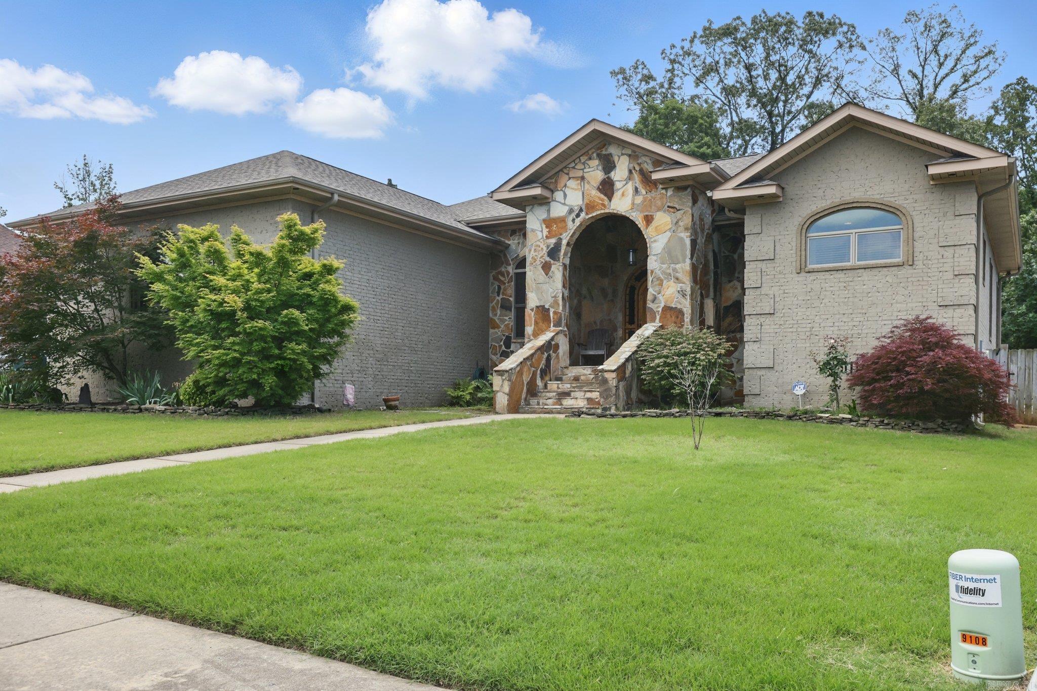 Welcome home to this stunning, one-level custom residence in The Woodlands—built, owned, and lovingly maintained by its original builder. Every detail of this home is a testament to craftsmanship, from the arched alder wood entry to the rainbow flagstone-wrapped porch. Step inside to soaring vaulted ceilings, rich custom oak floors, and beautiful natural light. The chef’s kitchen is a showstopper, featuring quartersawn oak cabinetry, granite countertops, and arched doorways that tie the entire space together with elegance & warmth. The private primary suite is a true retreat, complete with vaulted cedar-beamed ceilings, dual walk-in closets, a soaking tub, and a spacious walk-in shower. A separate guest suite with a fully tiled ADA roll-in shower and private deck access makes for an ideal mother-in-law or multigenerational setup. Enjoy outdoor living year-round under your covered porch or the 16x22’ gazebo, surrounded by mature trees and a fully fenced backyard—perfect for entertaining or simply unwinding. With custom woodwork throughout and a rare one-owner history, this home is a standout.