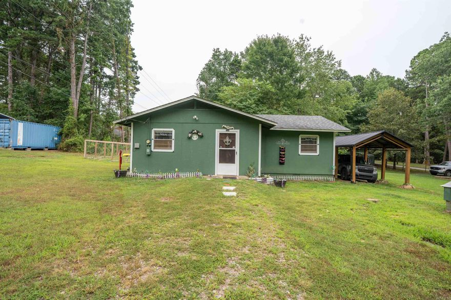 Cottage getaway at the lake. This super cute 2 bedroom 1 bath has lots of updates and an open living/kitchen concept. The updates include a new mini split, fenced yard, one car covered parking and city water. The two sheds, inflatable lake toys, metal carport, refrigerator, freezer and microwave will convey to the buyer. The furnishings are also negotiable to make this cottage turn key. The neighborhood offers easy lake access with its own boat launch for a yearly fee of $65 to utilize.