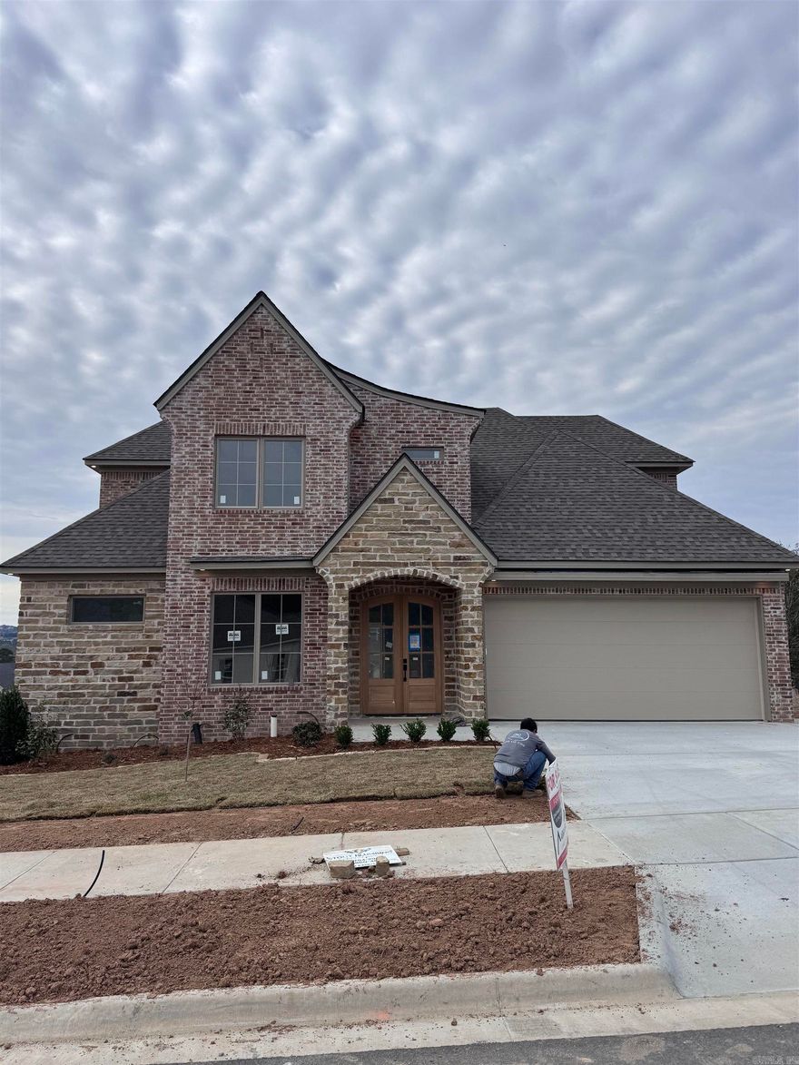 We're excited to introduce Mountain Brook, West Little Rock's newest and most desirable neighborhood. This community is conveniently located off Highway 10, just behind The Ranch and the Bank OZK campus, and only minutes away from Little Rock Christian, Joe T. Robinson, and Don Roberts Elementary.  This family-friendly home design features a grand foyer and a spacious open living area with 10-foot ceilings and 8-foot wood doors throughout. The kitchen is equipped with custom-built cabinets, an oversized pantry, and a wet bar off the living room, perfect for entertaining. Step outside to a large covered patio where you can enjoy sunset views of Chenal Mountain.  The master suite boasts a decadent design, including huge walk-in closets, a luxurious tub, and a supersized walk-in shower with two shower heads. This home also offers a private office downstairs, with three additional bedrooms, three full bathrooms, and a separate playroom upstairs.  This home is set to be complete in April 2026. We invite you to come and explore it today!