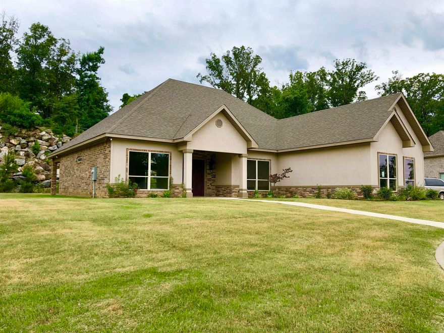 Located in the Lovely and Immaculately Kept Forest Lakes Neighborhood, a 55 and Better Community...This Elegant home is one of the Premier Show Homes and has many Enhanced Features--Soaring Ceilings through the Great Room, continue in to the Large Glassed in Sun-room that would be a perfect spot for a Grand Piano to be displayed! 8' Doors--Office could easily be 3rd bedroom by adding a door--Gas Starter Fireplace in great rm and updated Lighting package add to the ambiance of this Spacious home! Large Boulders brought in from North Arkansas Frame the serene back yard/patio setting. Extra options include--All Residents must join Community Clubhouse with Pool, Event Center & Workout Facility-- Raised Gardens, Woodworking Shop, & Artist Studio.Fee is $30 per month!